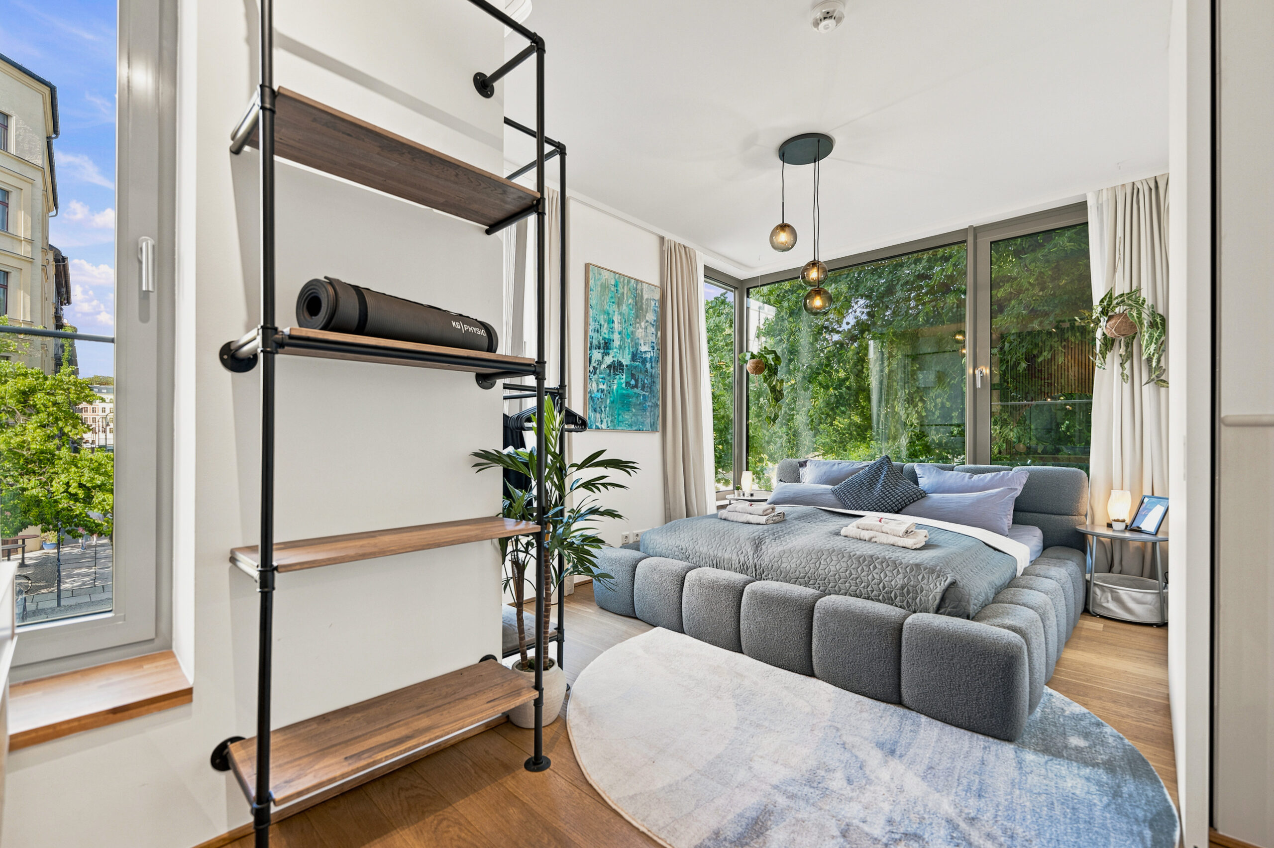 Spacious bedroom with large windows and modern furniture