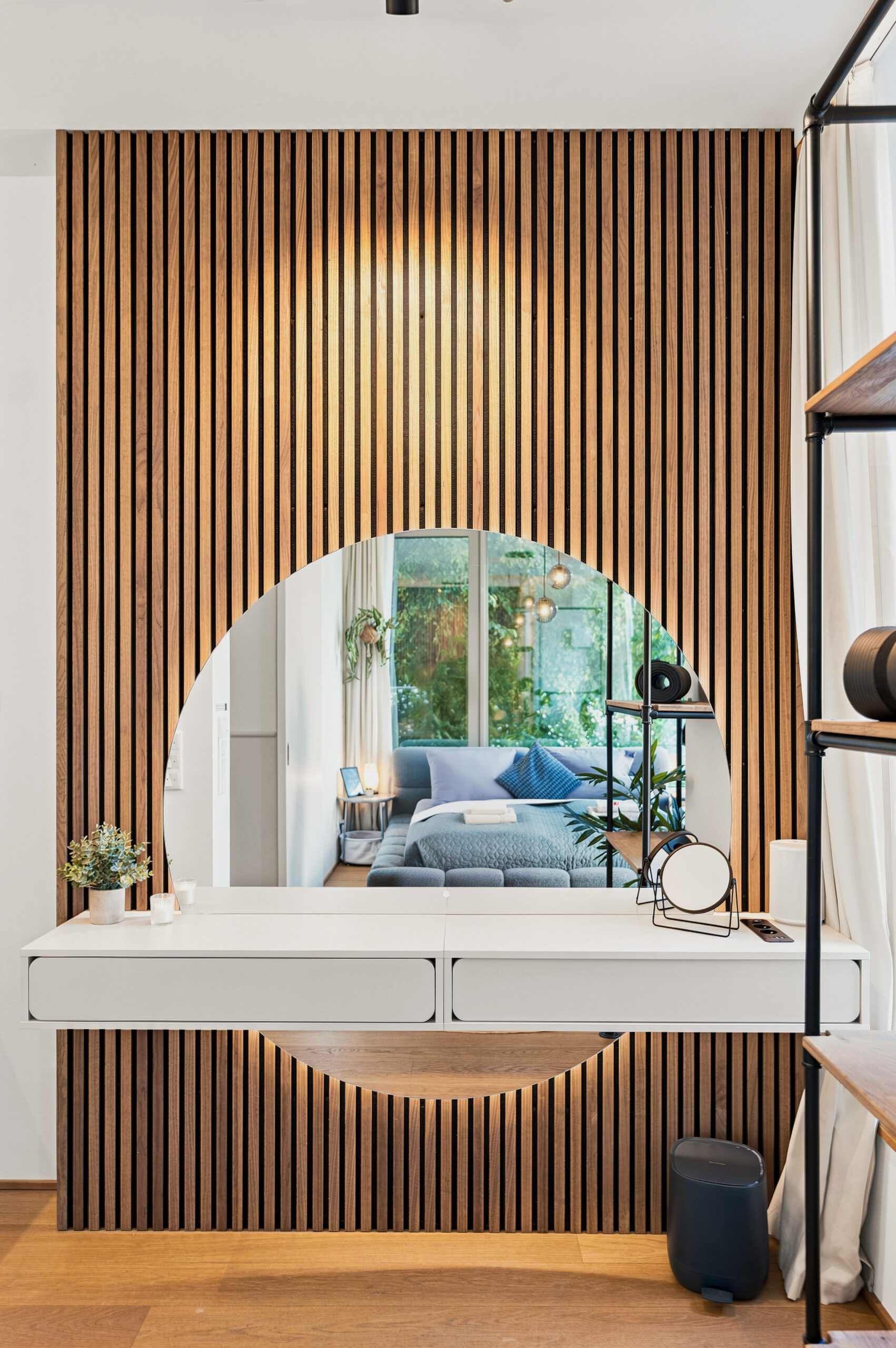 Bedroom nook with wooden slat wall and window view