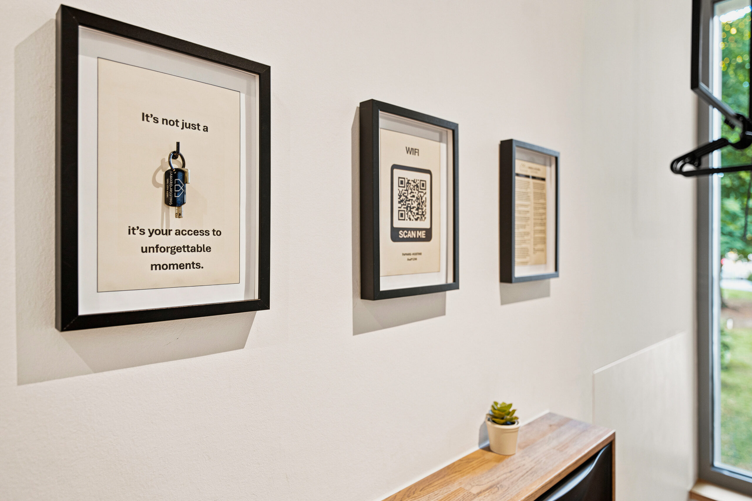 Wall-mounted framed artwork on white hallway wall