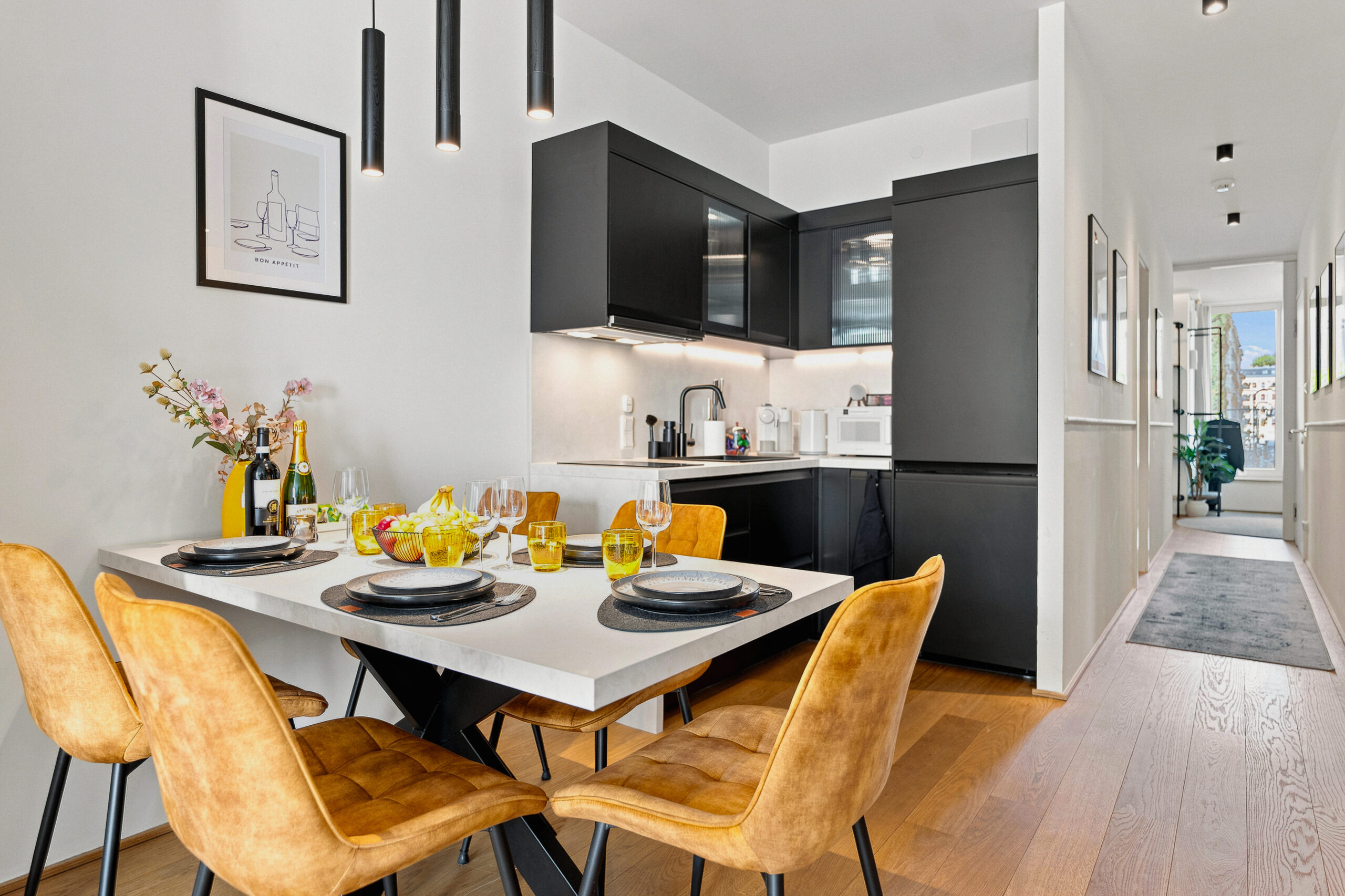 Contemporary kitchen with dining area and yellow accent chairs