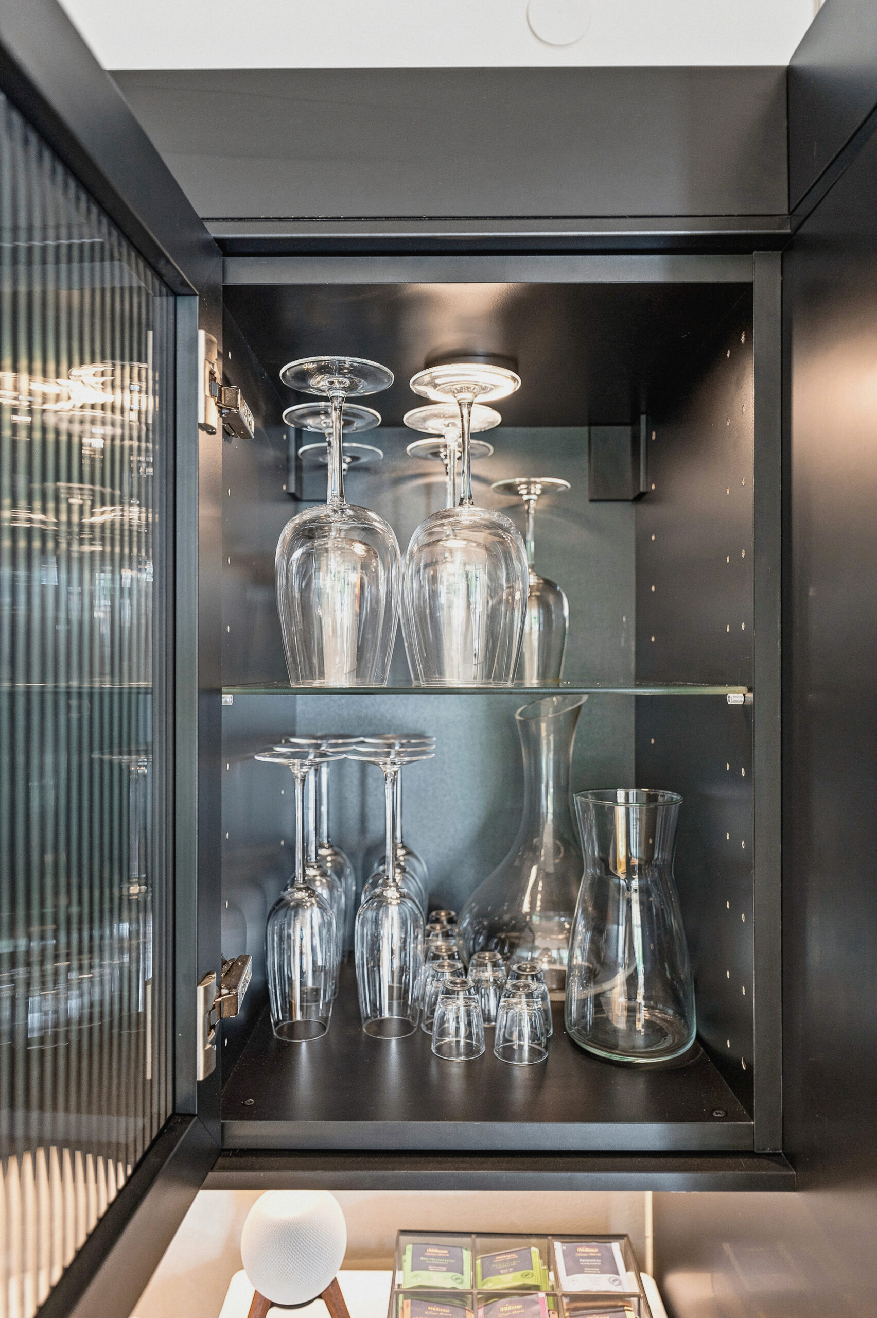 Detailed view of open cabinet with glassware display