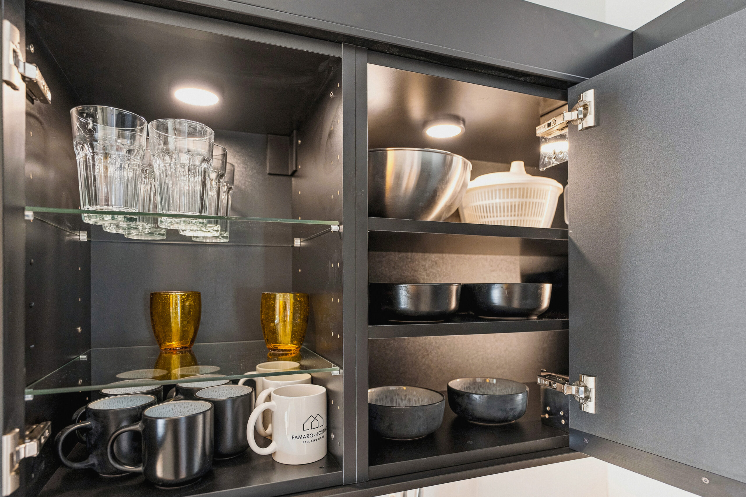 Open cabinet interior with organized kitchenware and glassware