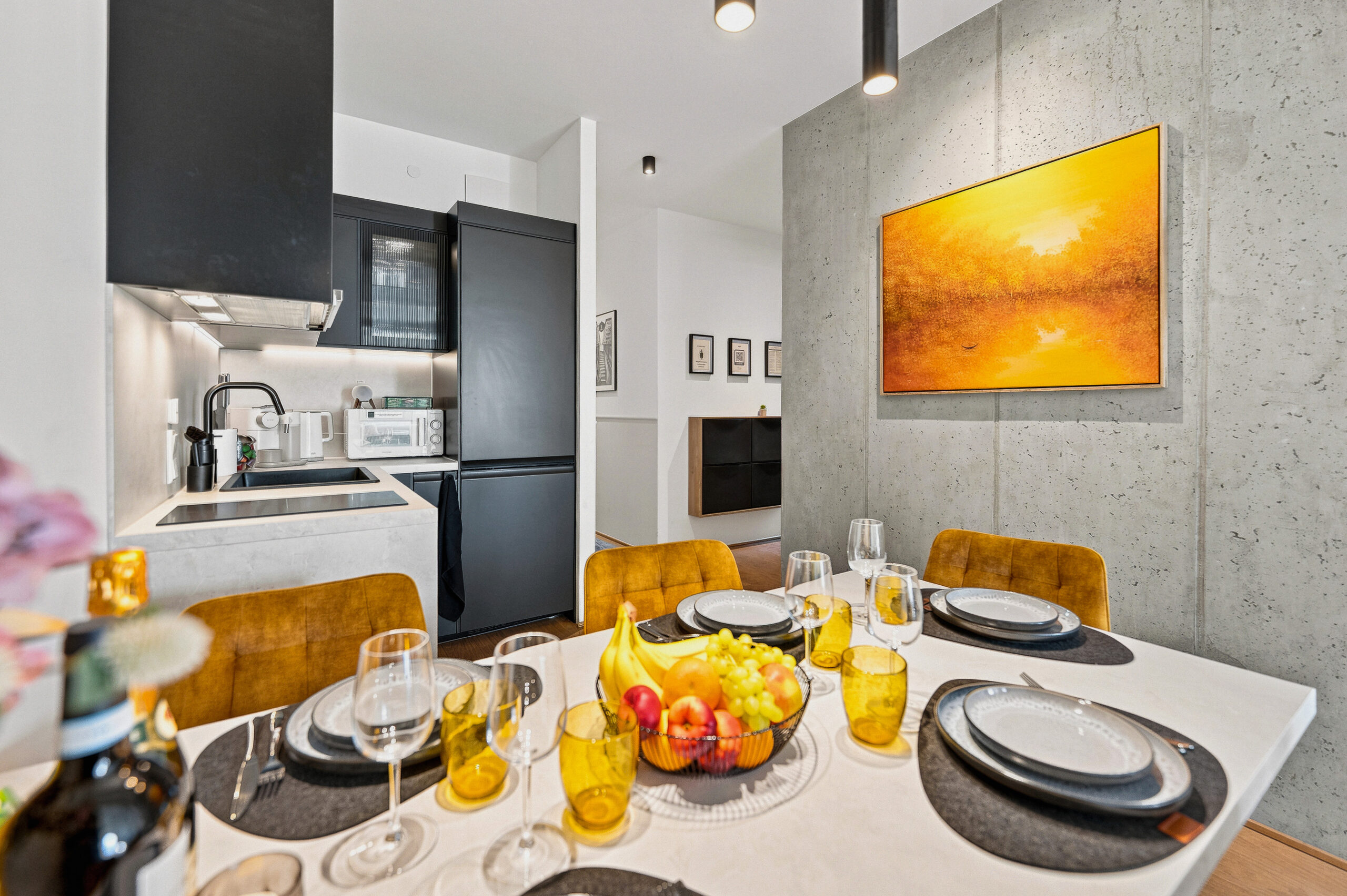 Modern compact kitchen and dining area with yellow accents