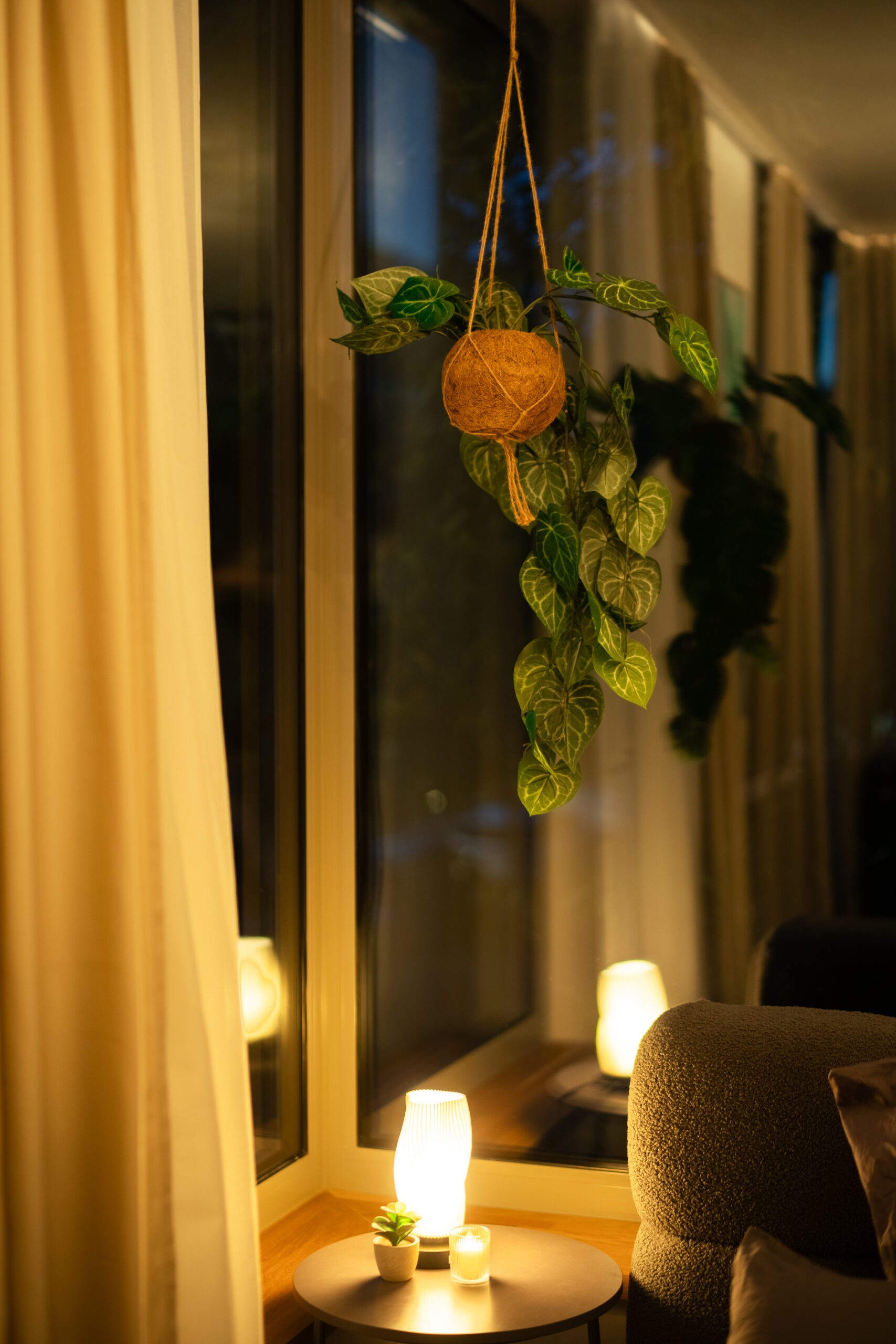 Minimalist balcony detail with plant and candles at dusk