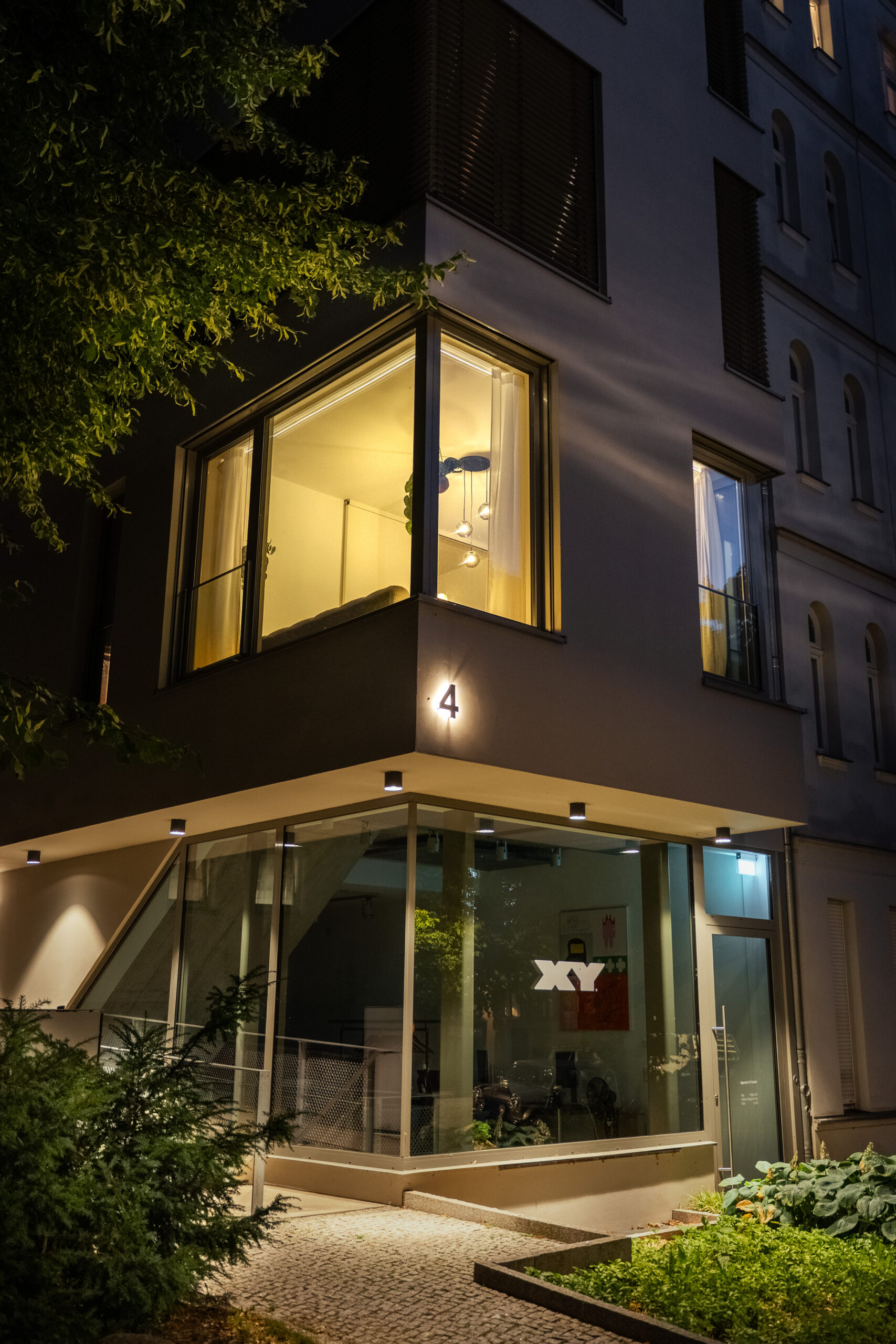 Contemporary corner unit exterior at night with illuminated windows