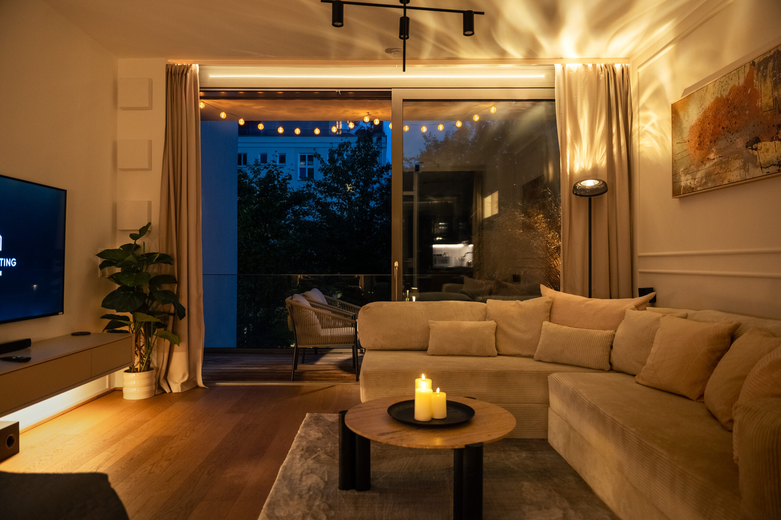 Modern living room with sofa, evening ambiance, large windows
