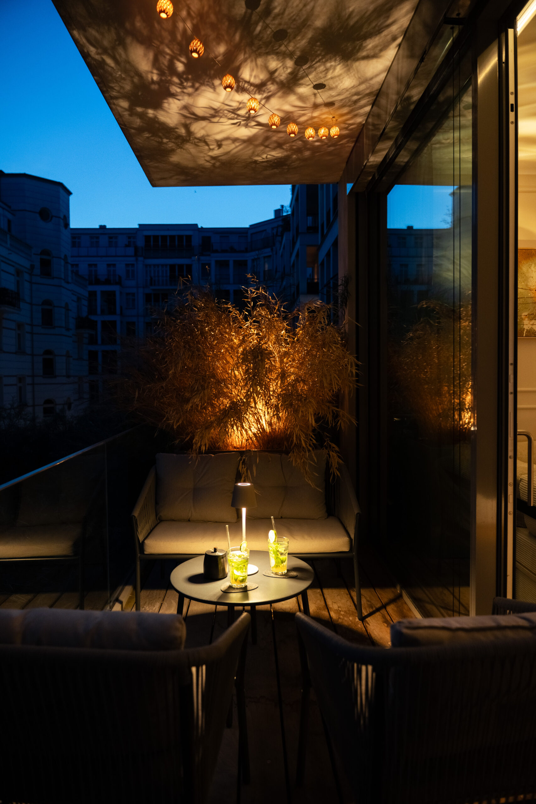 Evening rooftop terrace with dining table and ambient lighting