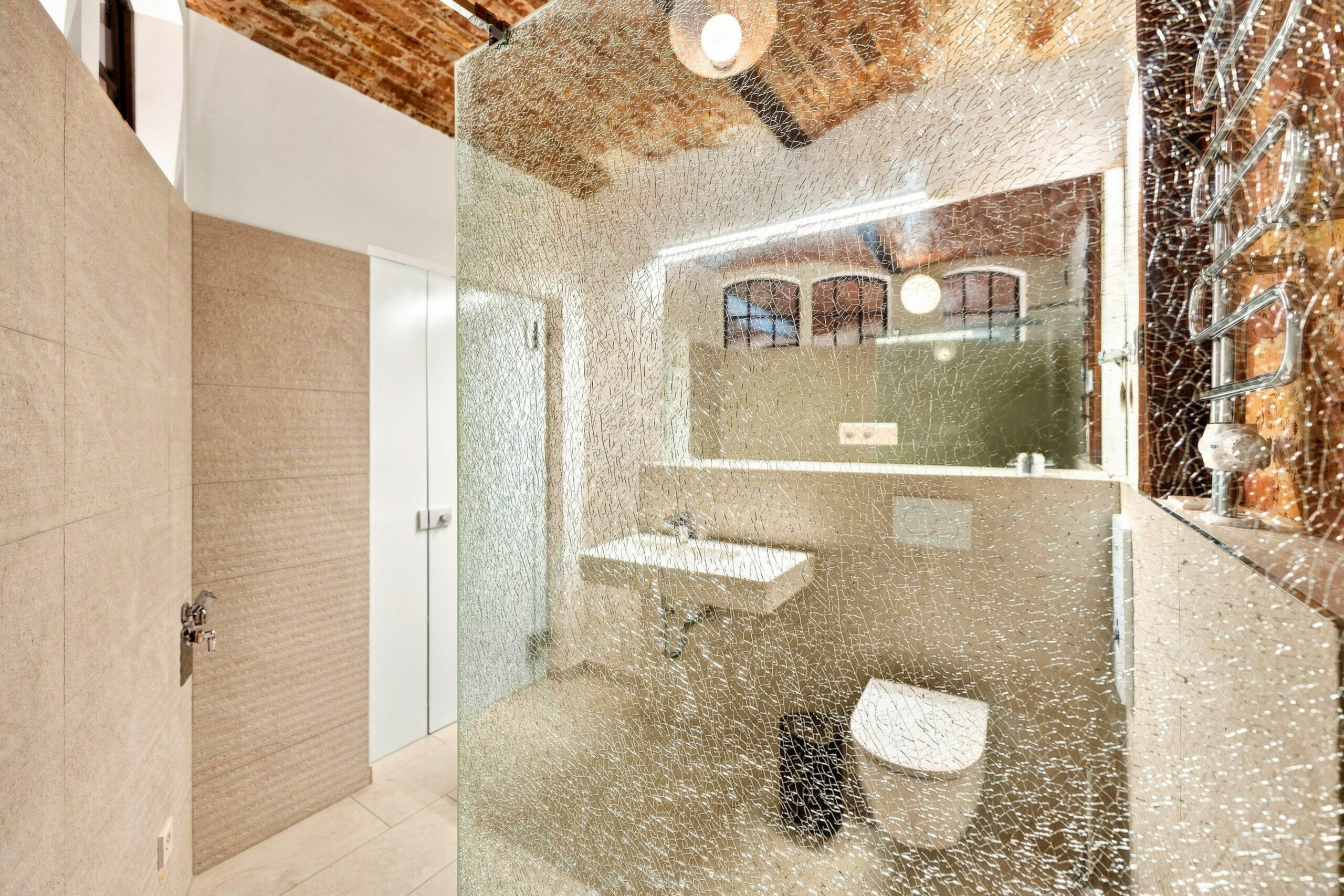 Luxury bathroom with textured walls, rainfall showerhead, and marble accents
