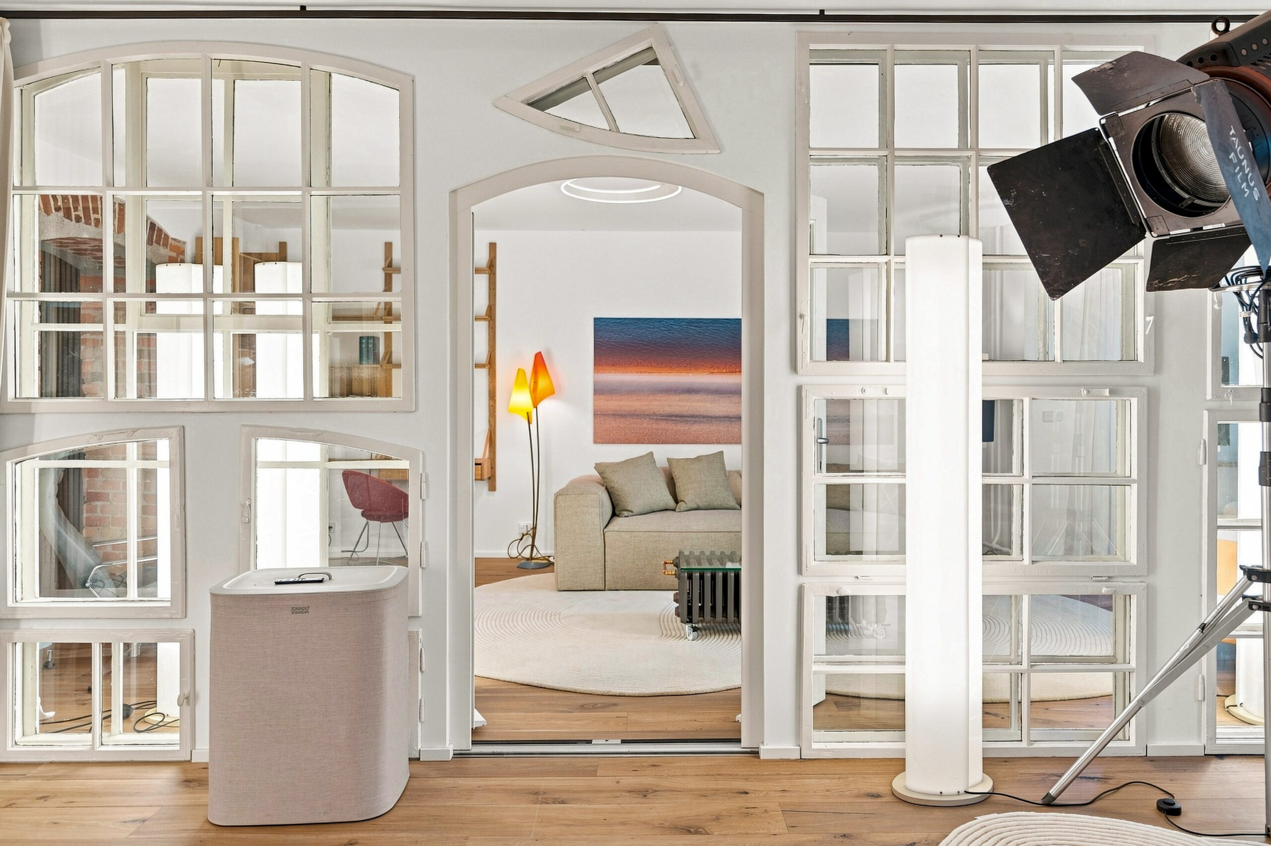 Staged bedroom with framed artwork, soft furnishings, open French doors