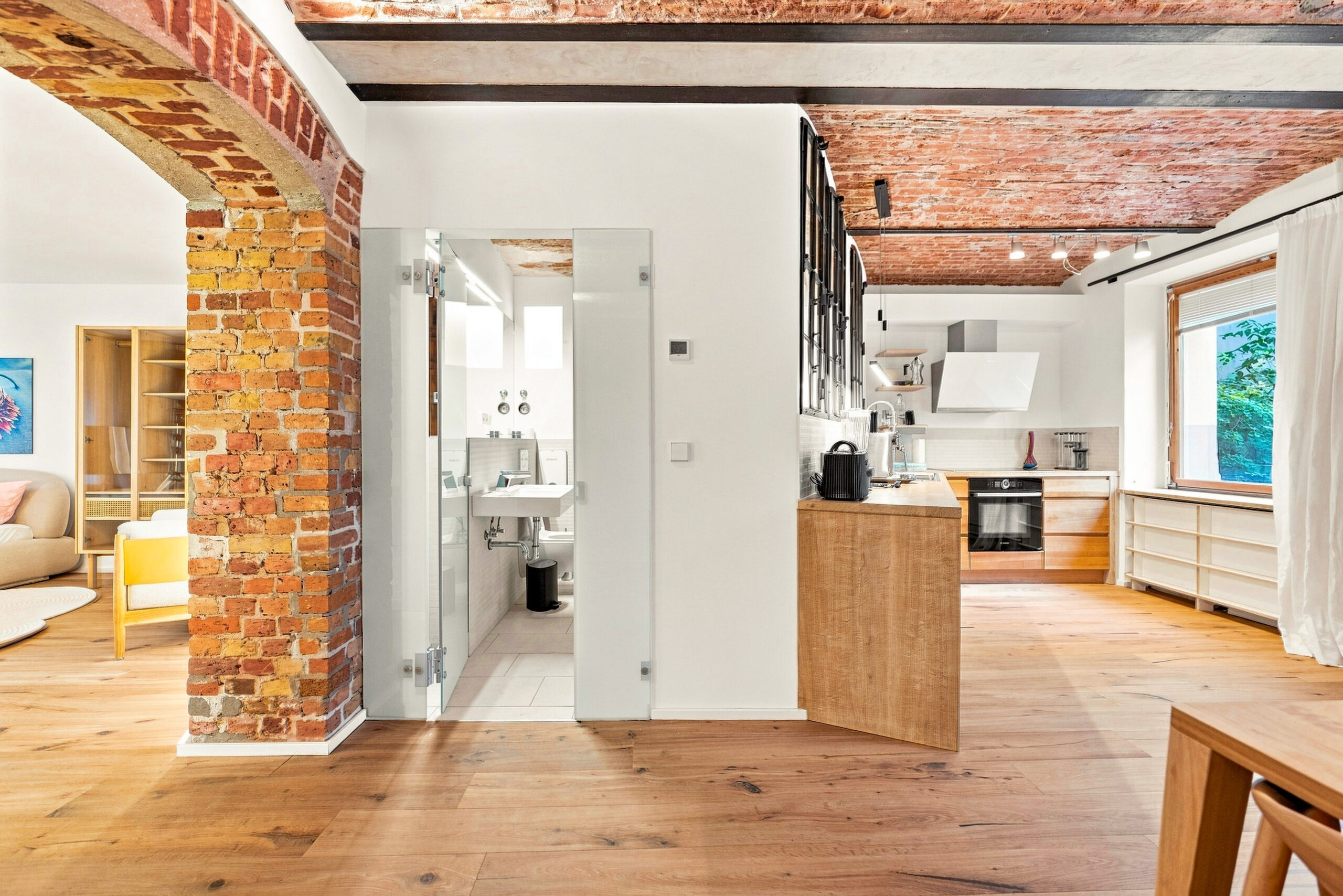 Industrial loft kitchen with red brick walls and wooden island