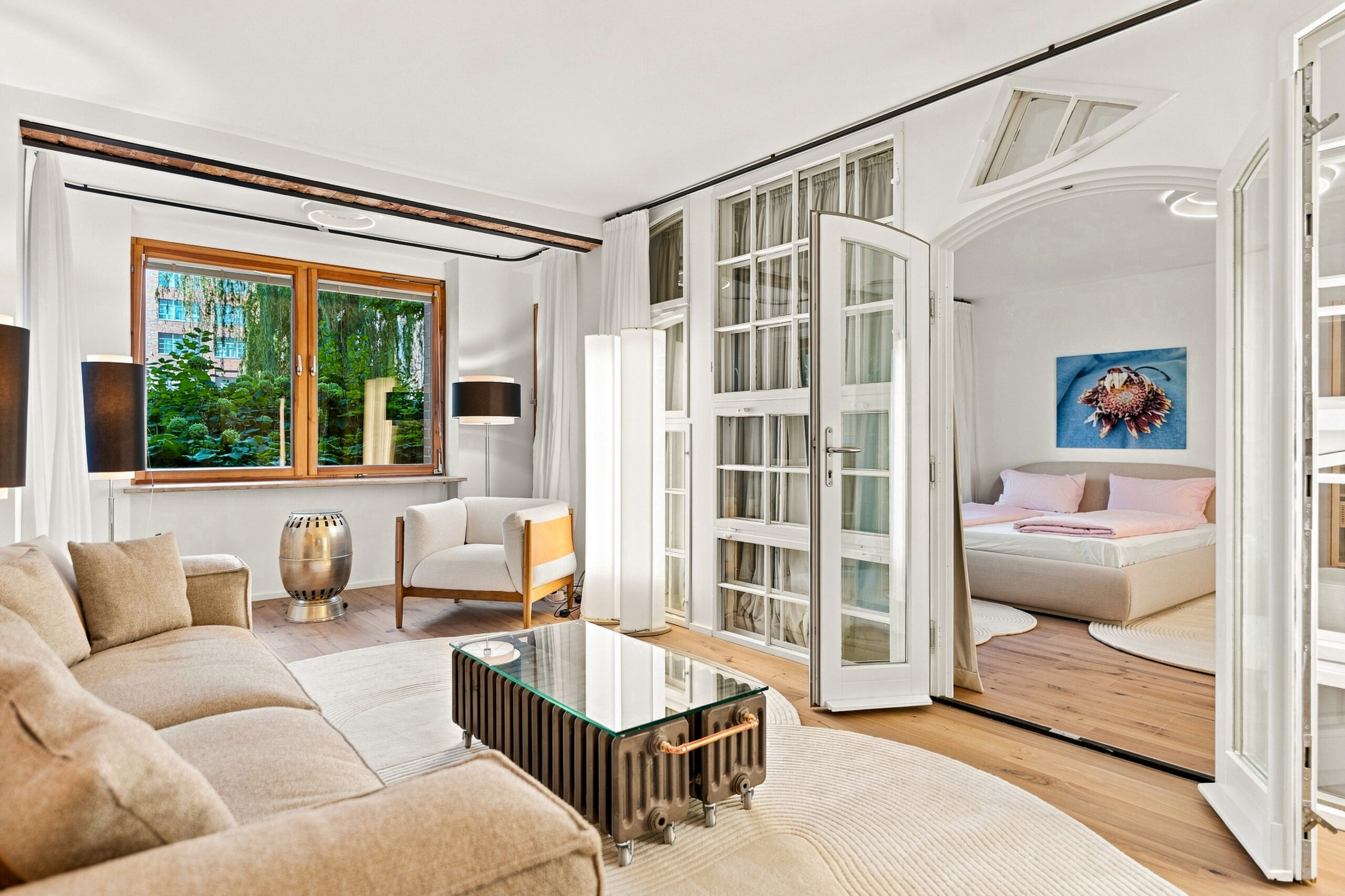 Spacious living room with cream sofa and exposed brick ceiling