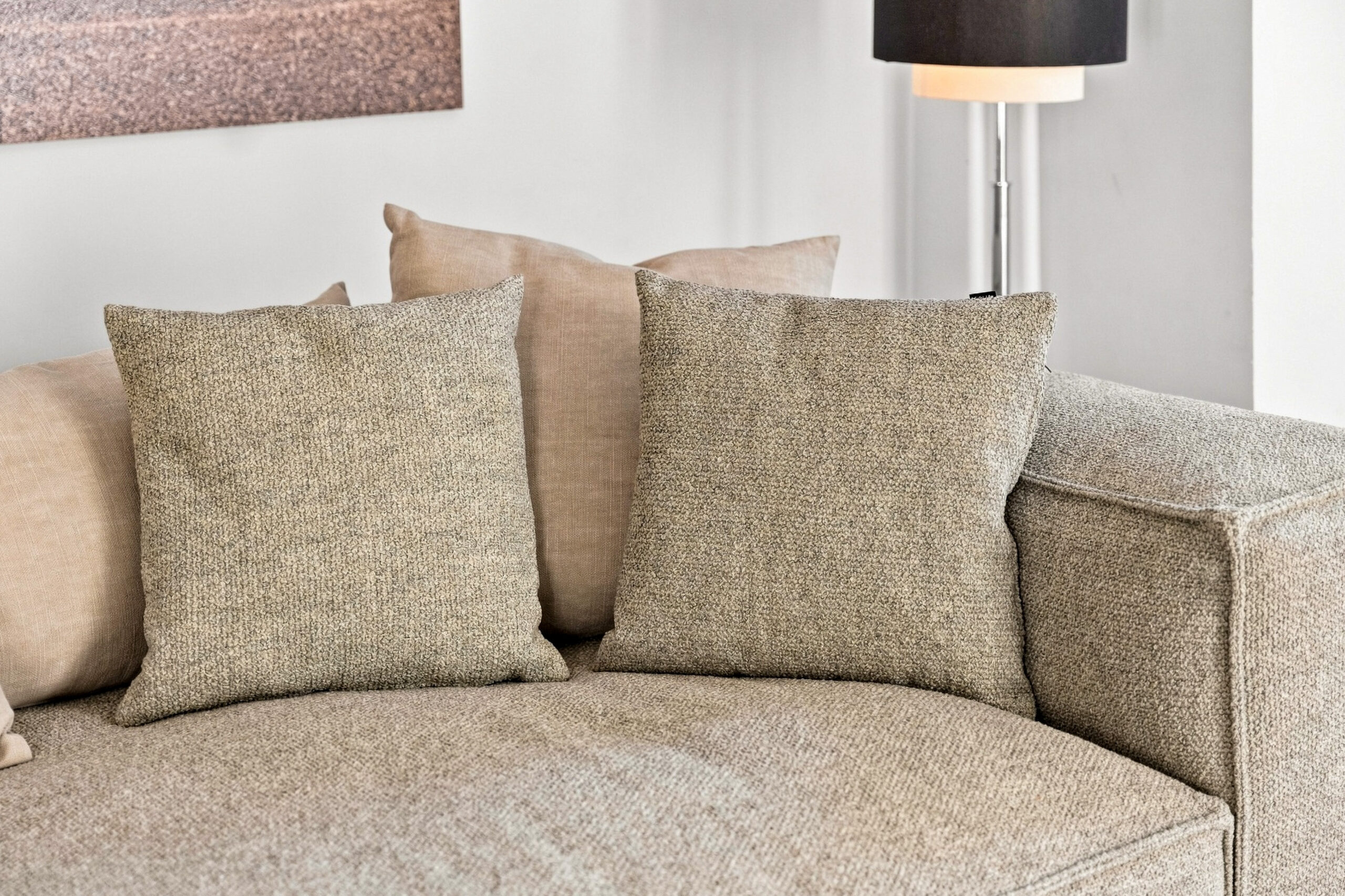 Beige sectional sofa cushions with neutral pillow styling