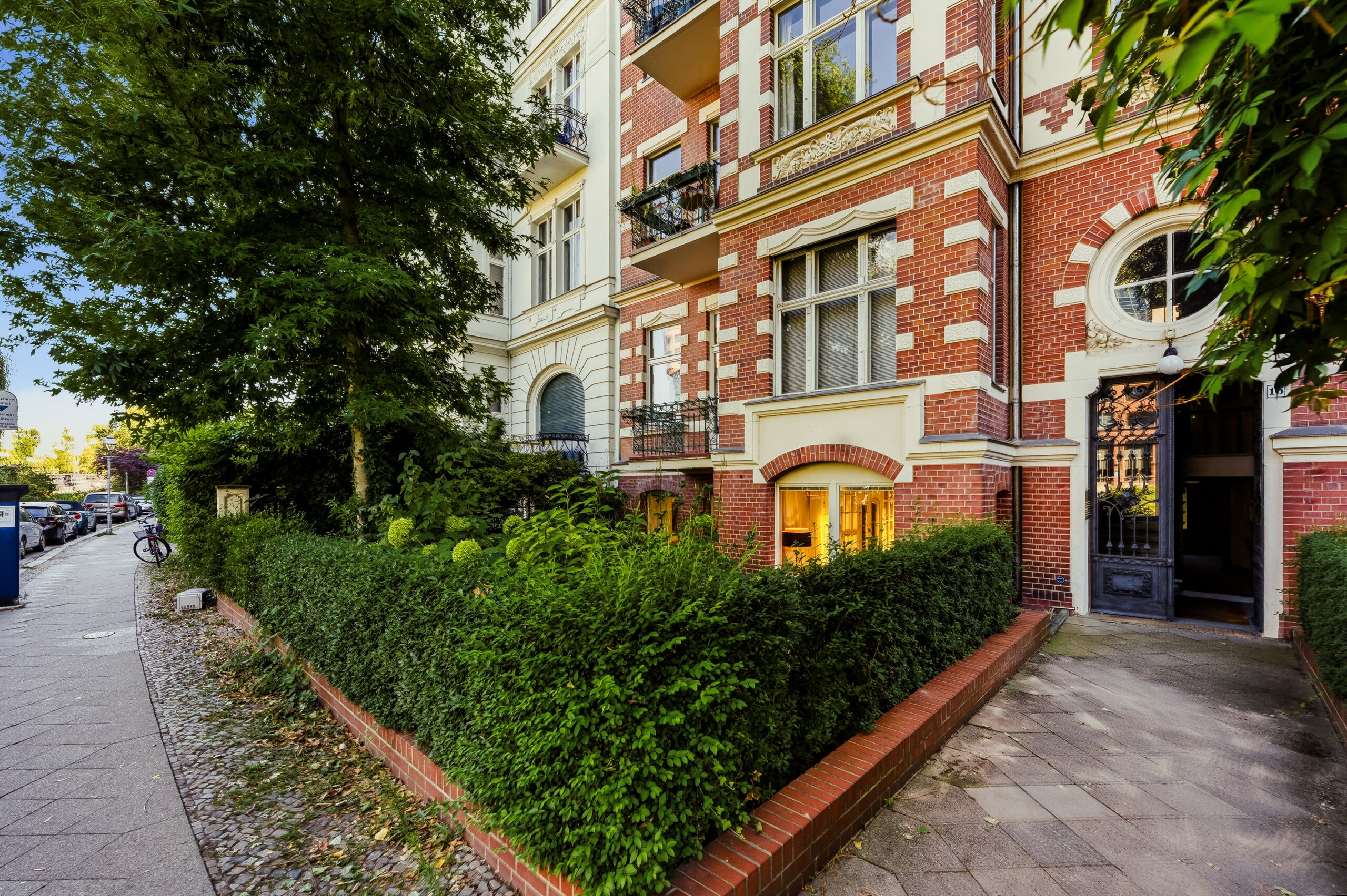 Brick apartment building with hedge screening and street frontage