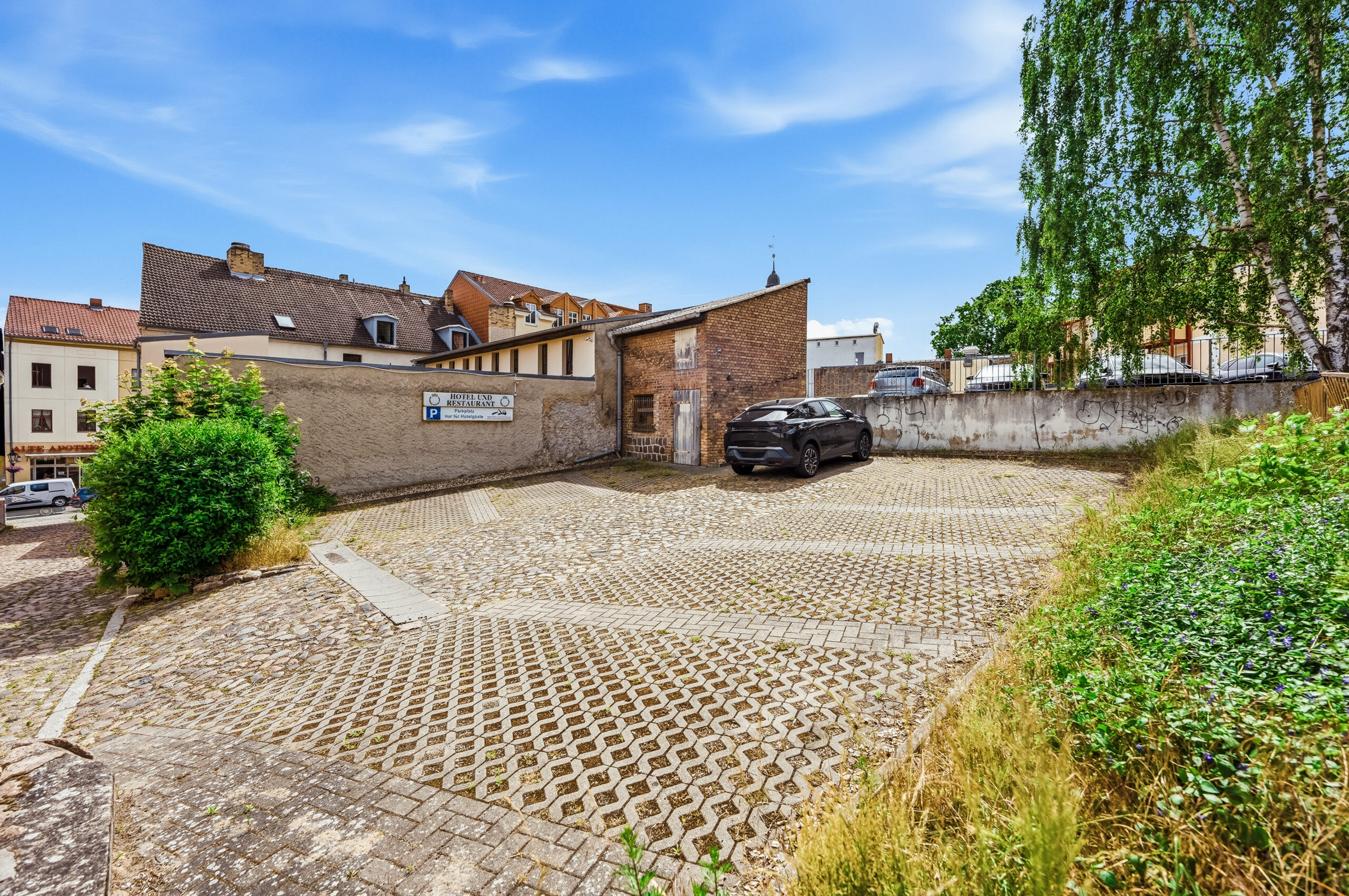 Paved parking lot beside brick building