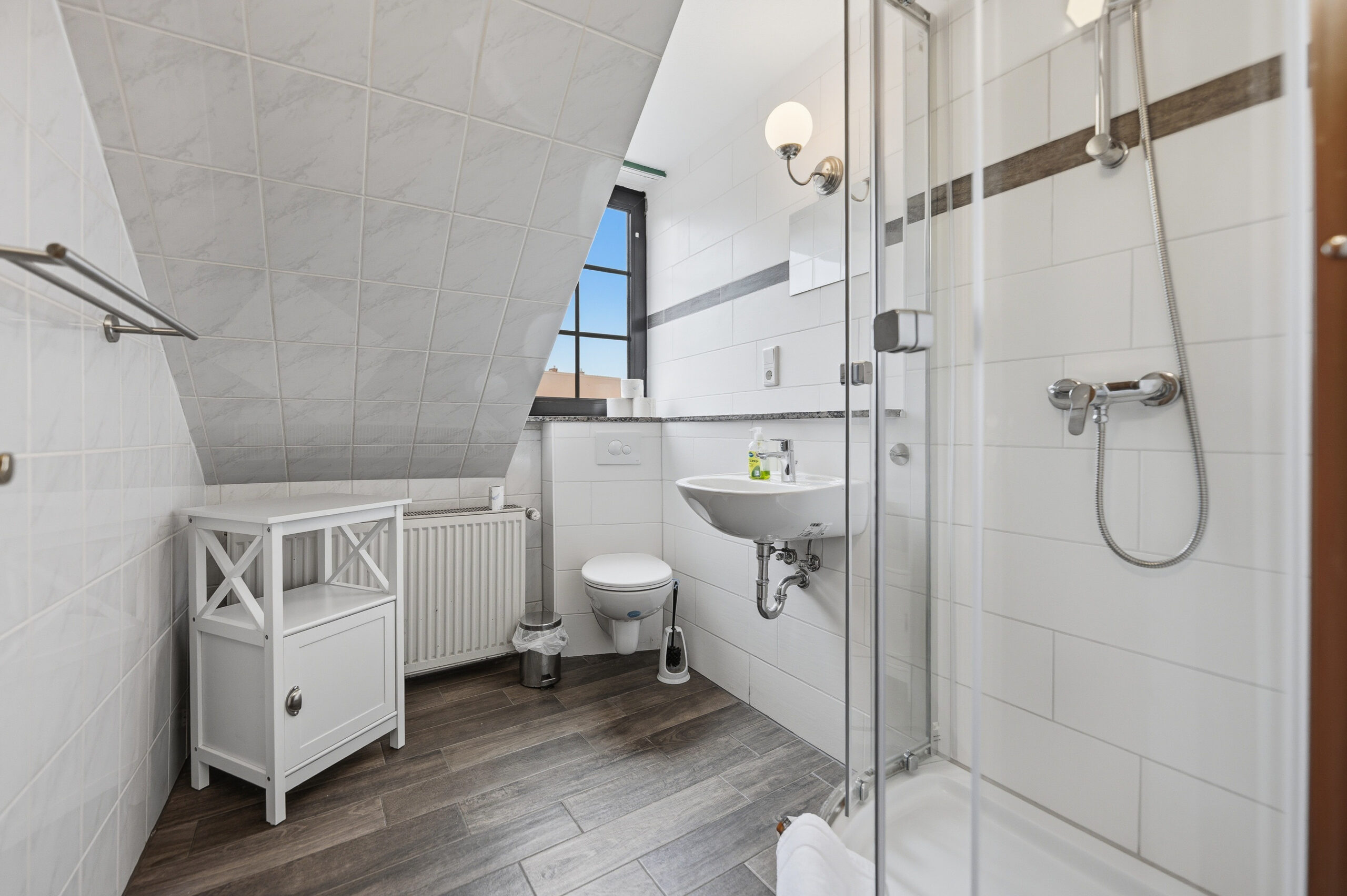 Attic bathroom with sloped ceiling and shower