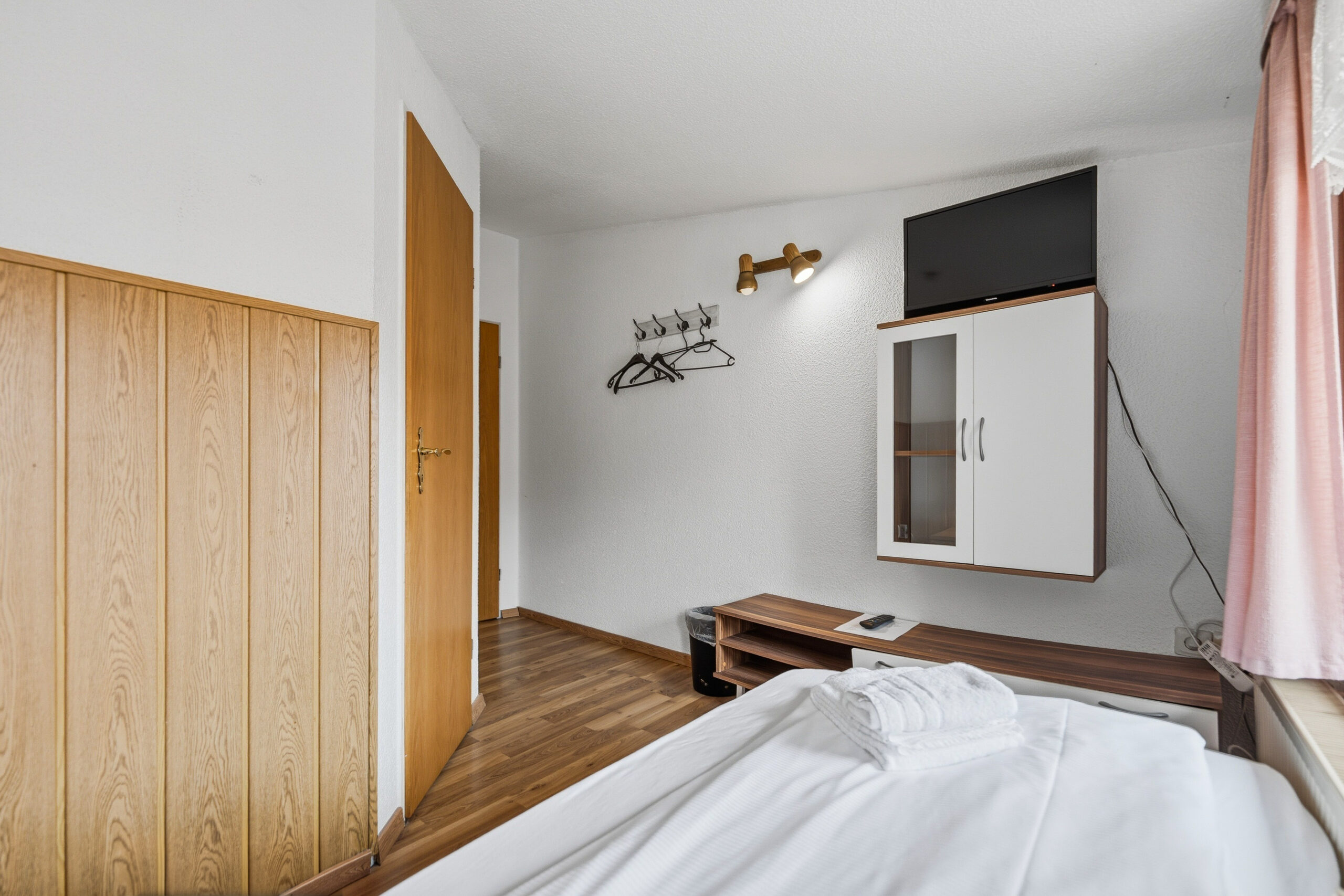 Bedroom with wall shelf and wood wardrobe