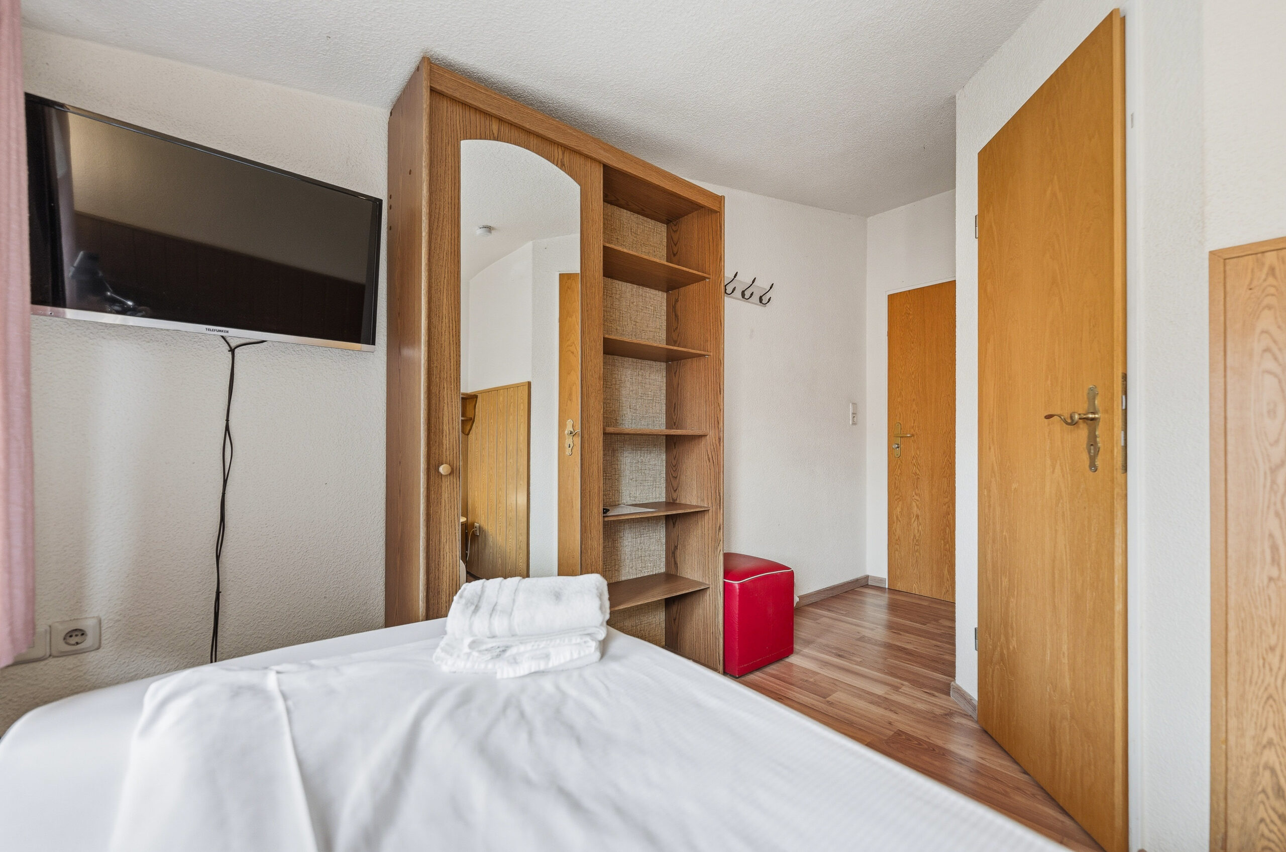 Bedroom with wardrobe and mirror, TV mounted
