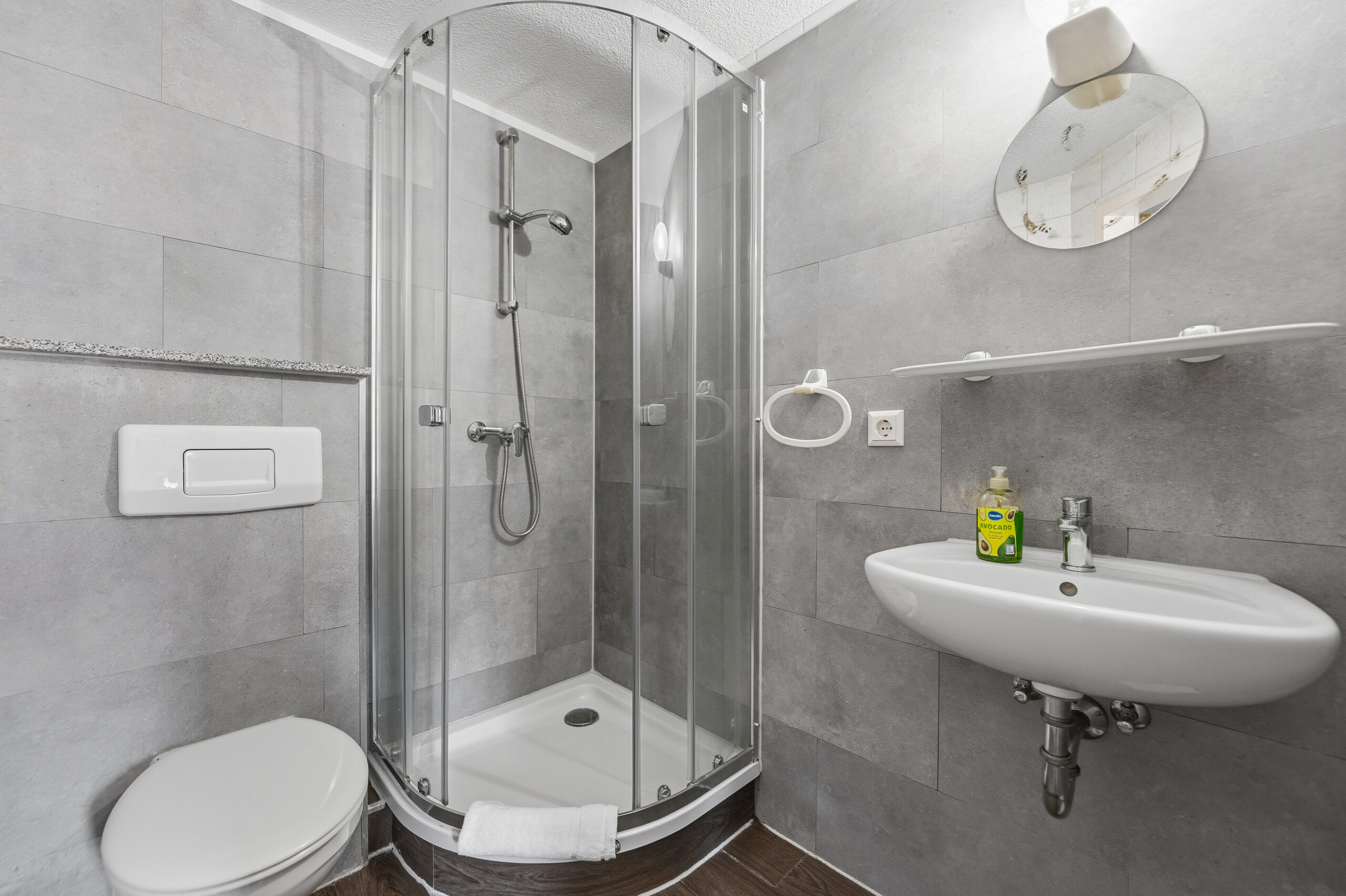 Modern grey bathroom with shower and sink
