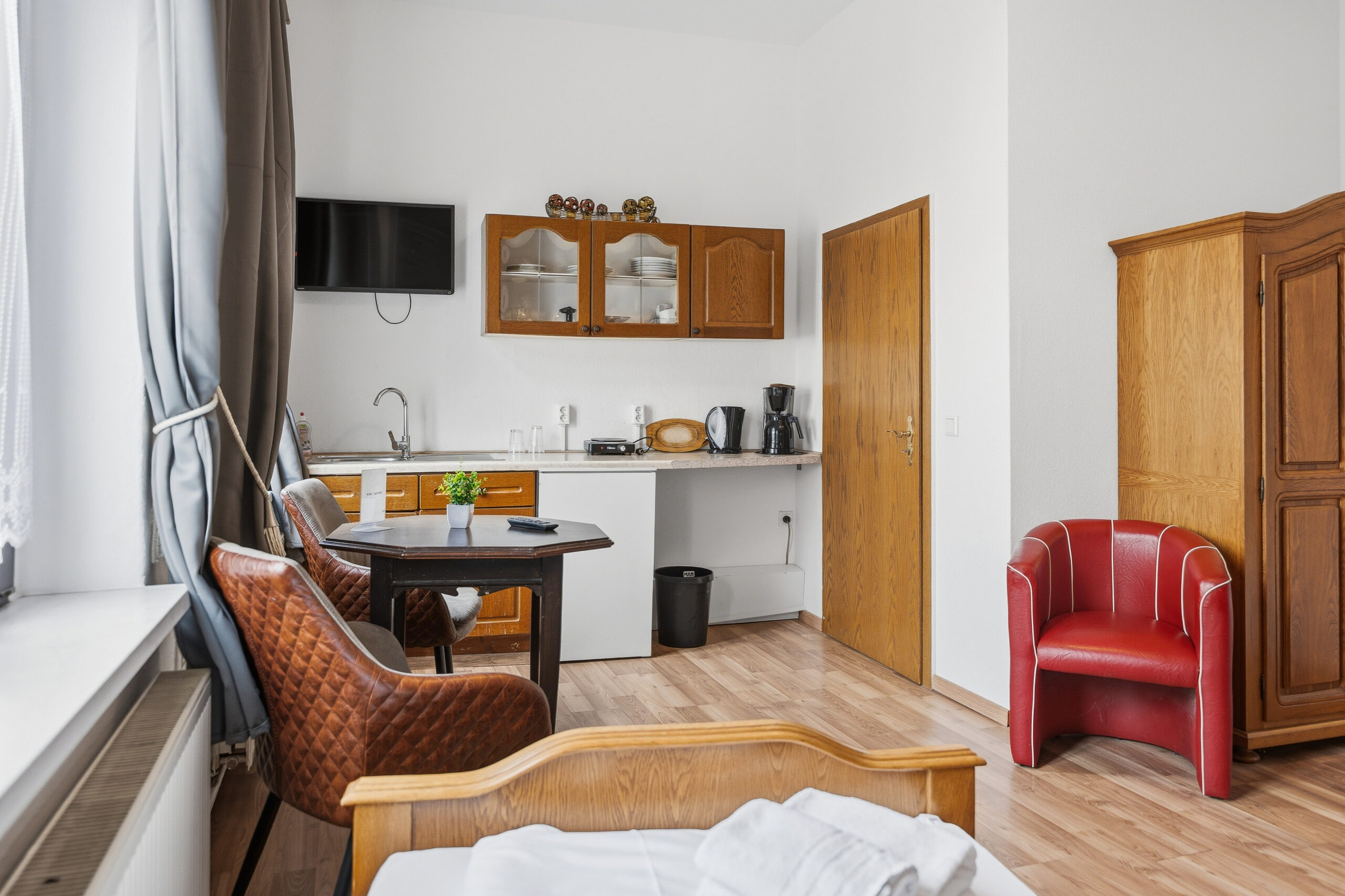 Kitchenette with dining table and armchairs