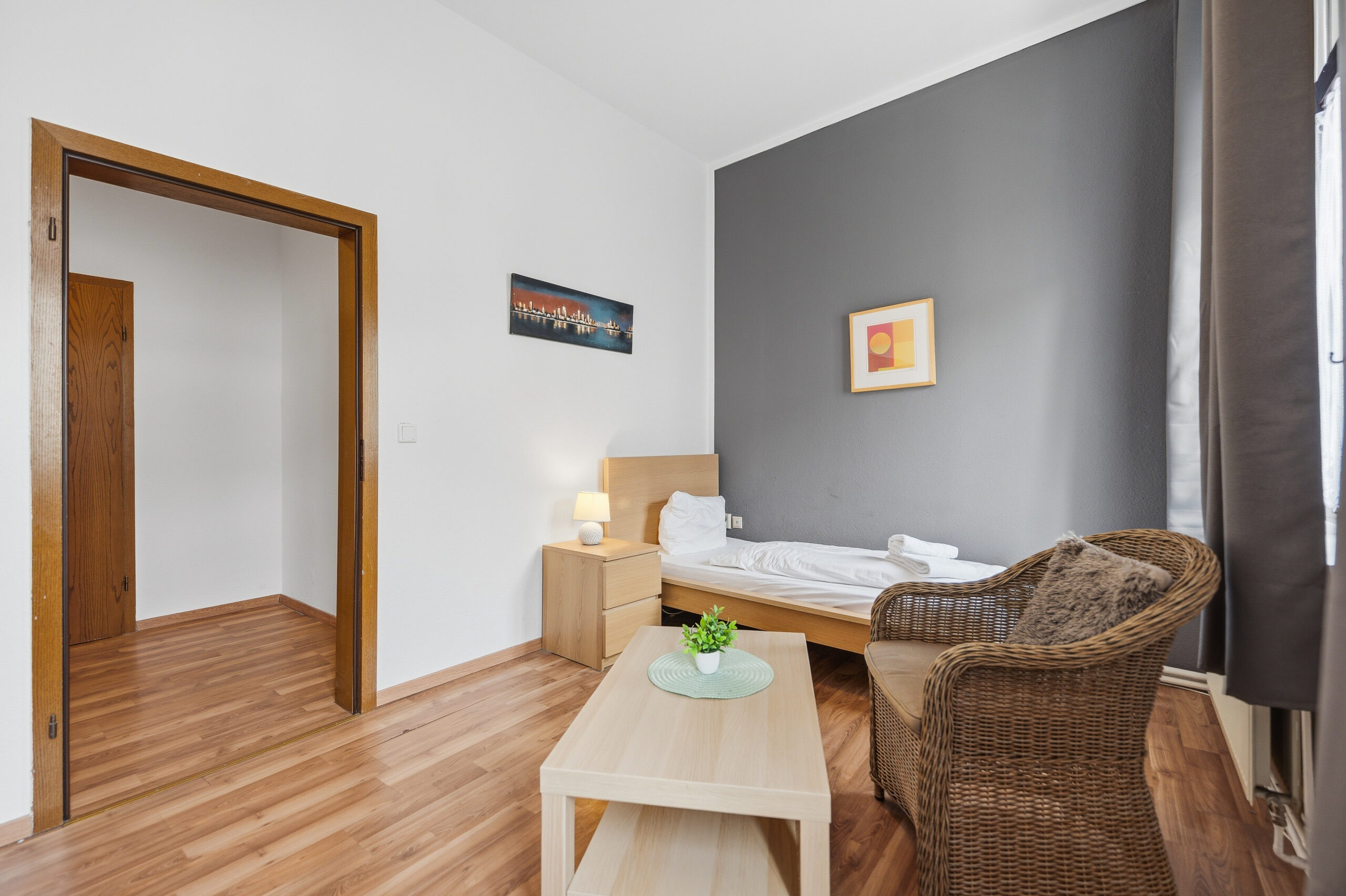 Bedroom with gray accent wall and armchair