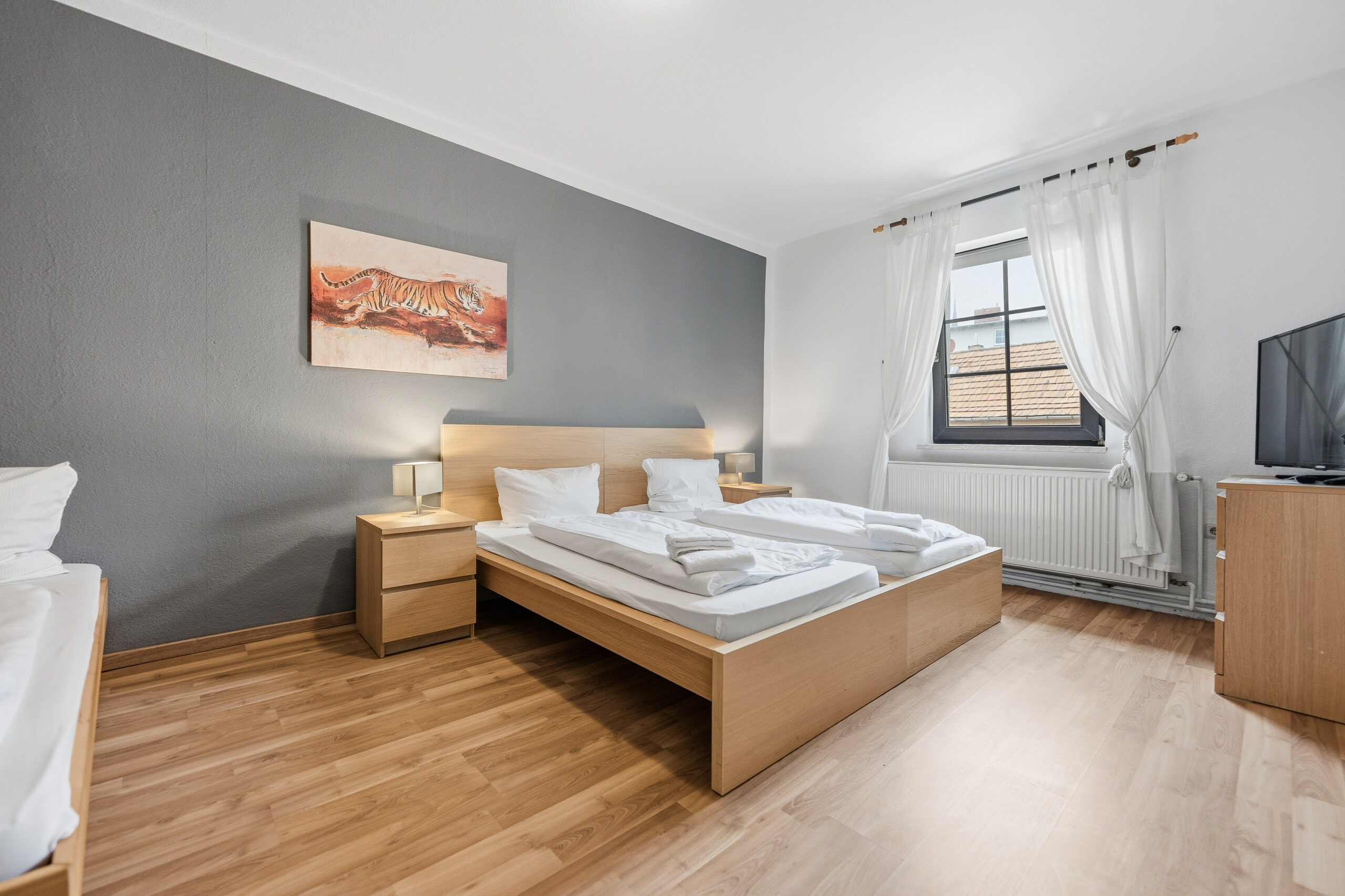 Double bed with gray accent wall