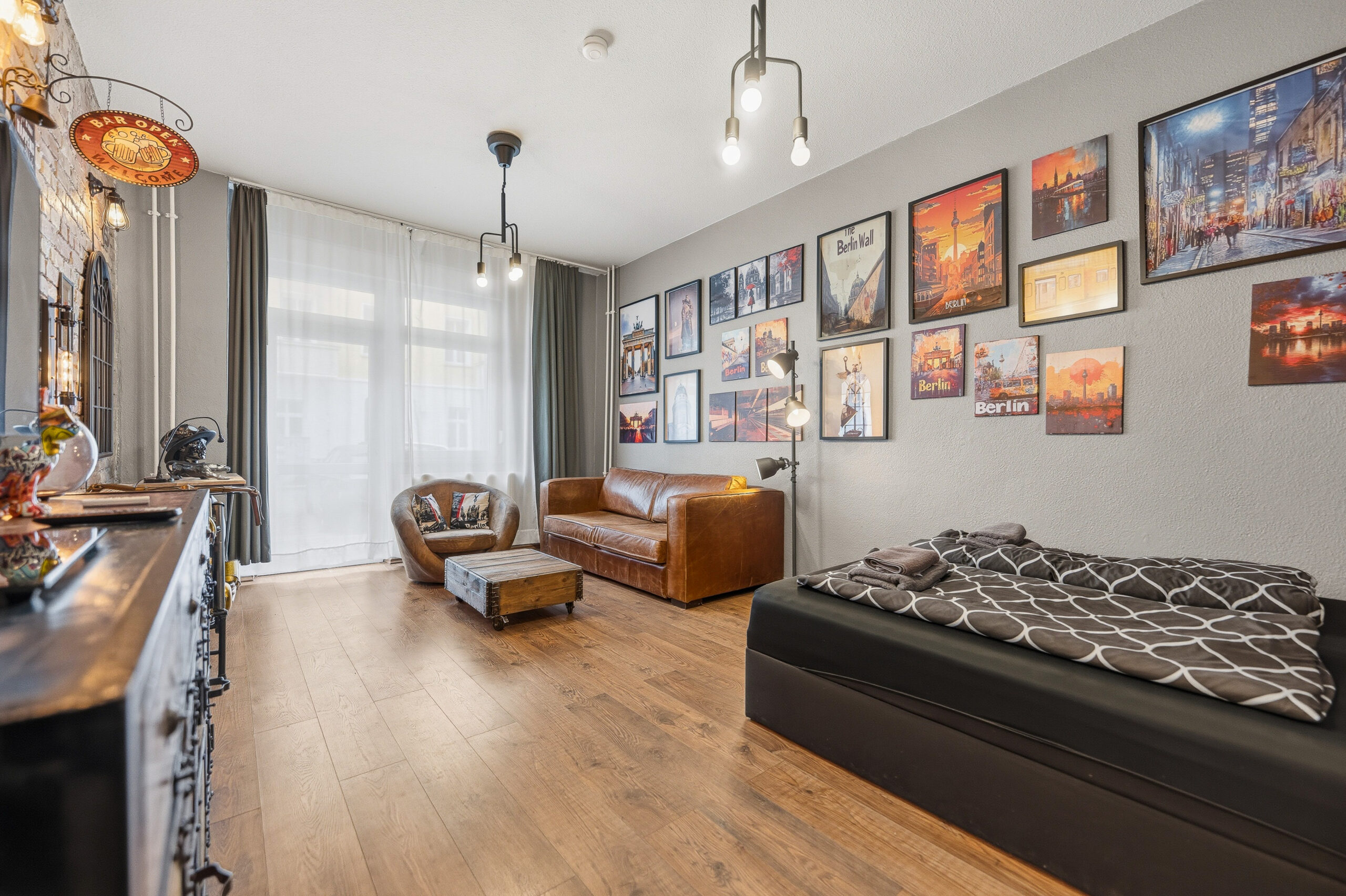 Long living space with sofa, armchair, and bed