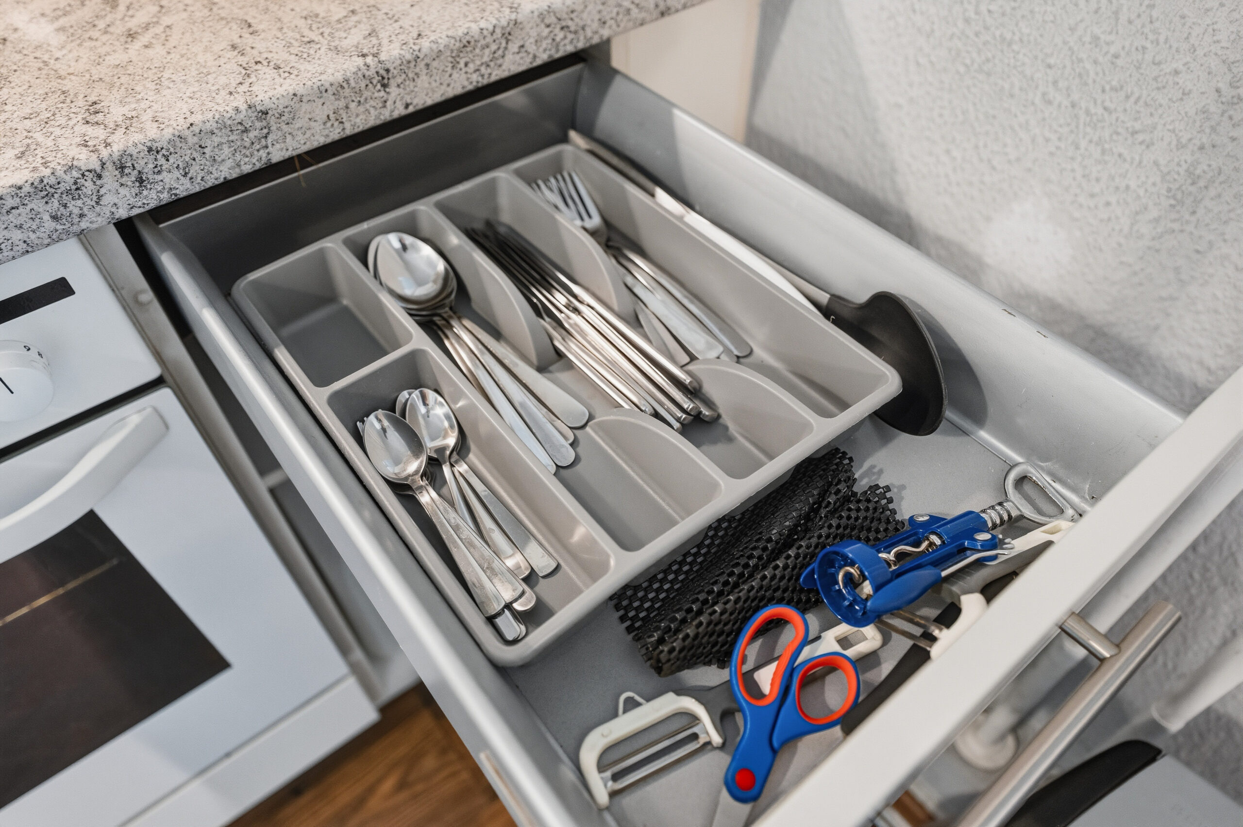 Open drawer with cutlery organizer