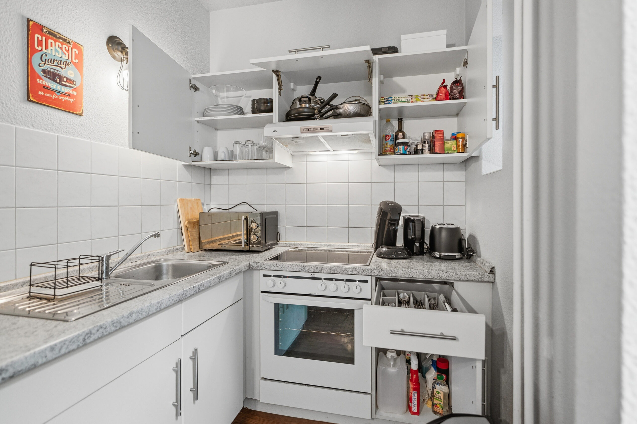 Compact white kitchen with open cabinets
