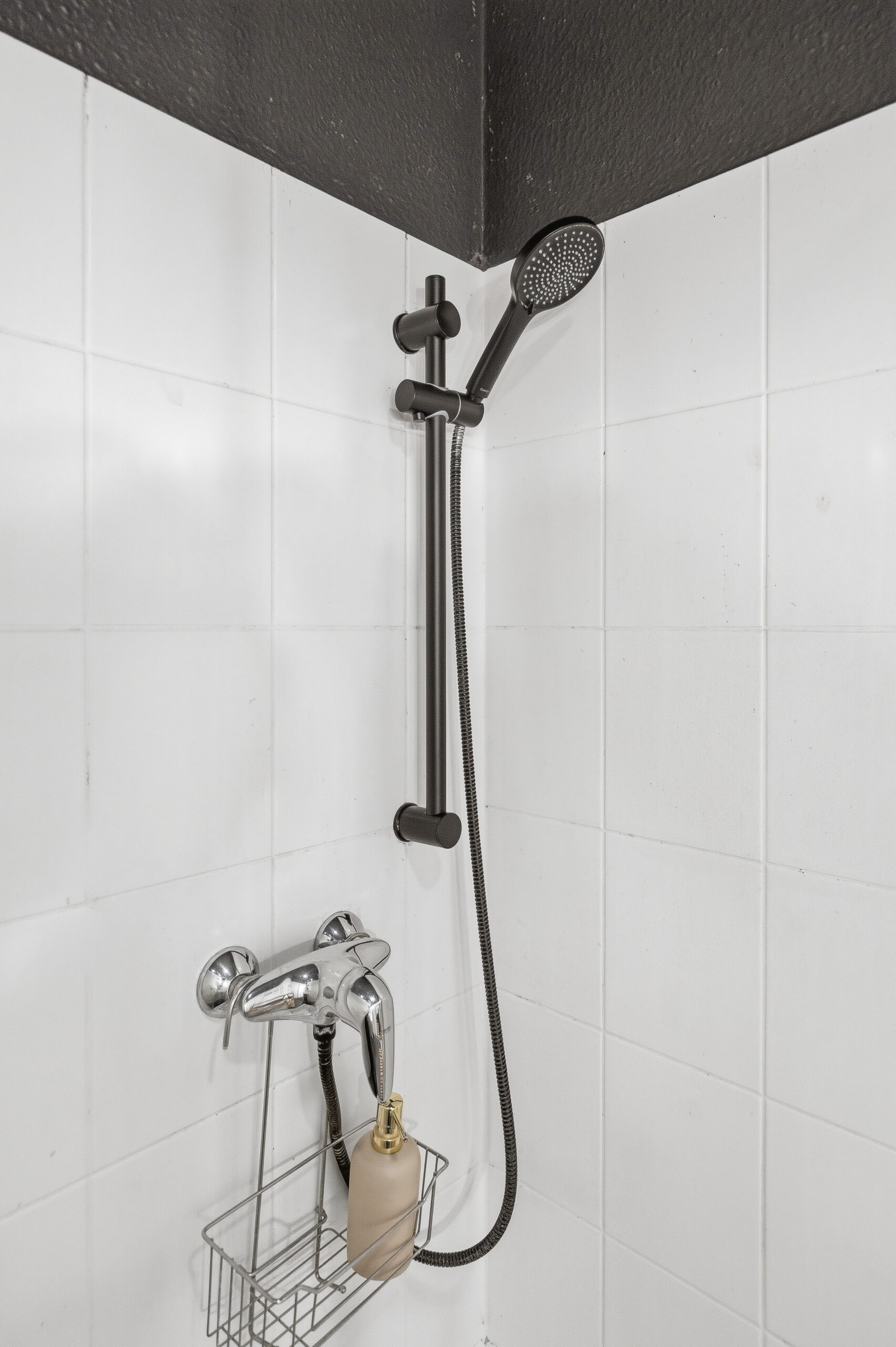 Close-up of shower head and faucet handle