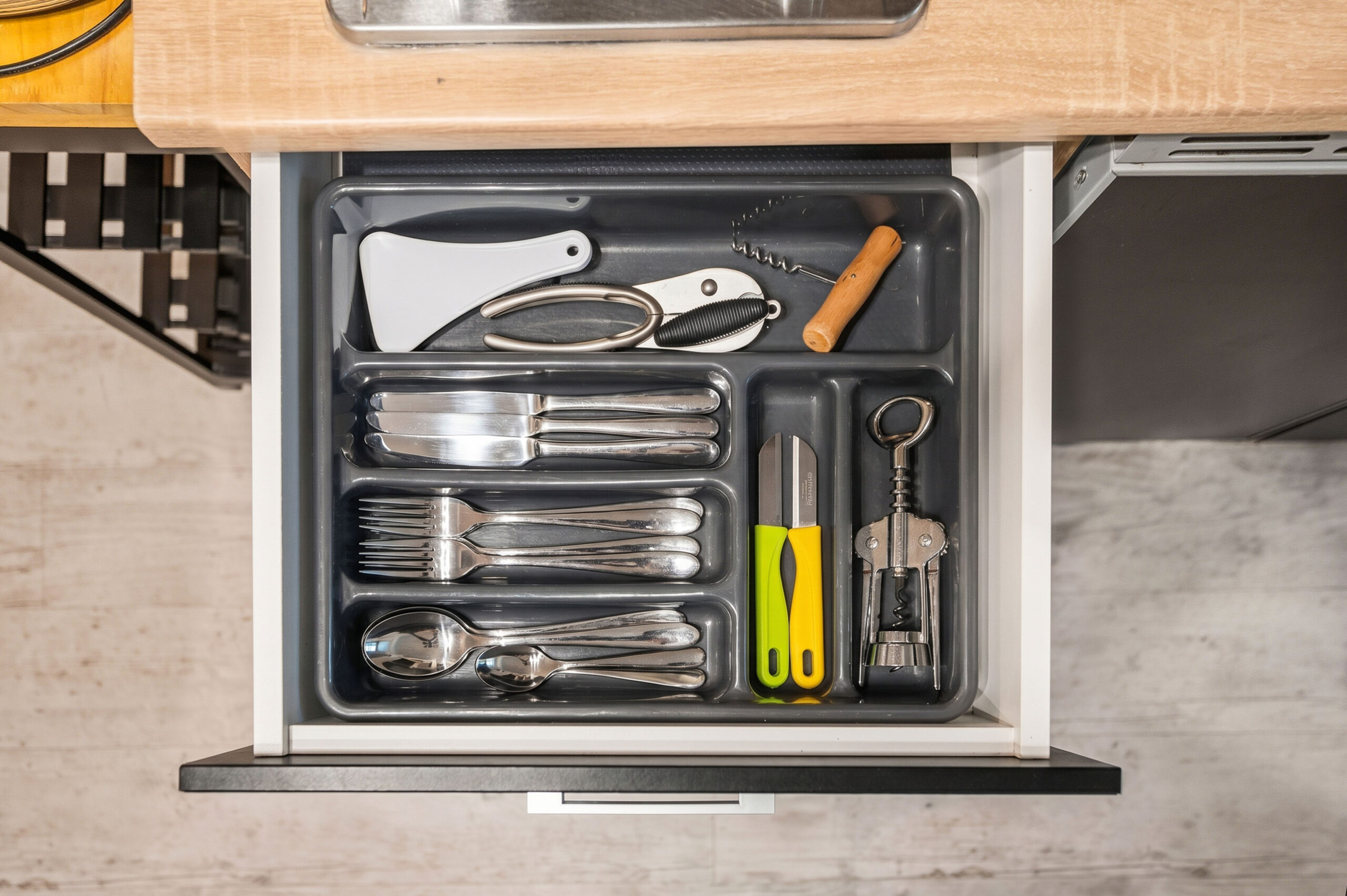 Organized kitchen drawer with utensils and cooking tools neatly arranged