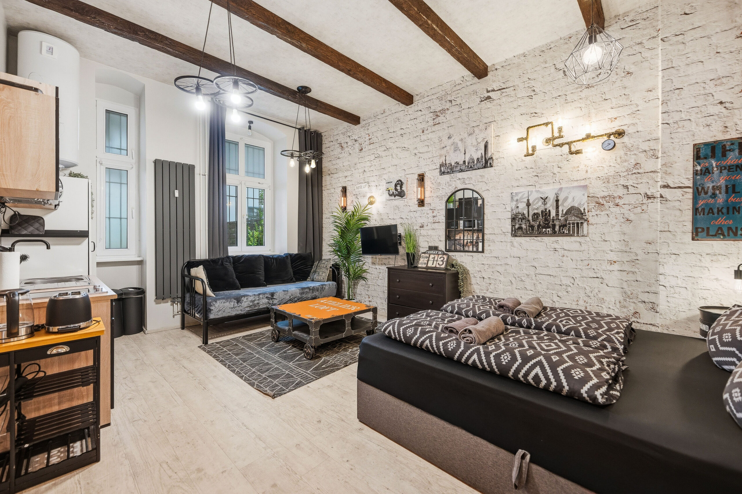 Full apartment view with bedroom, living and kitchen zones
