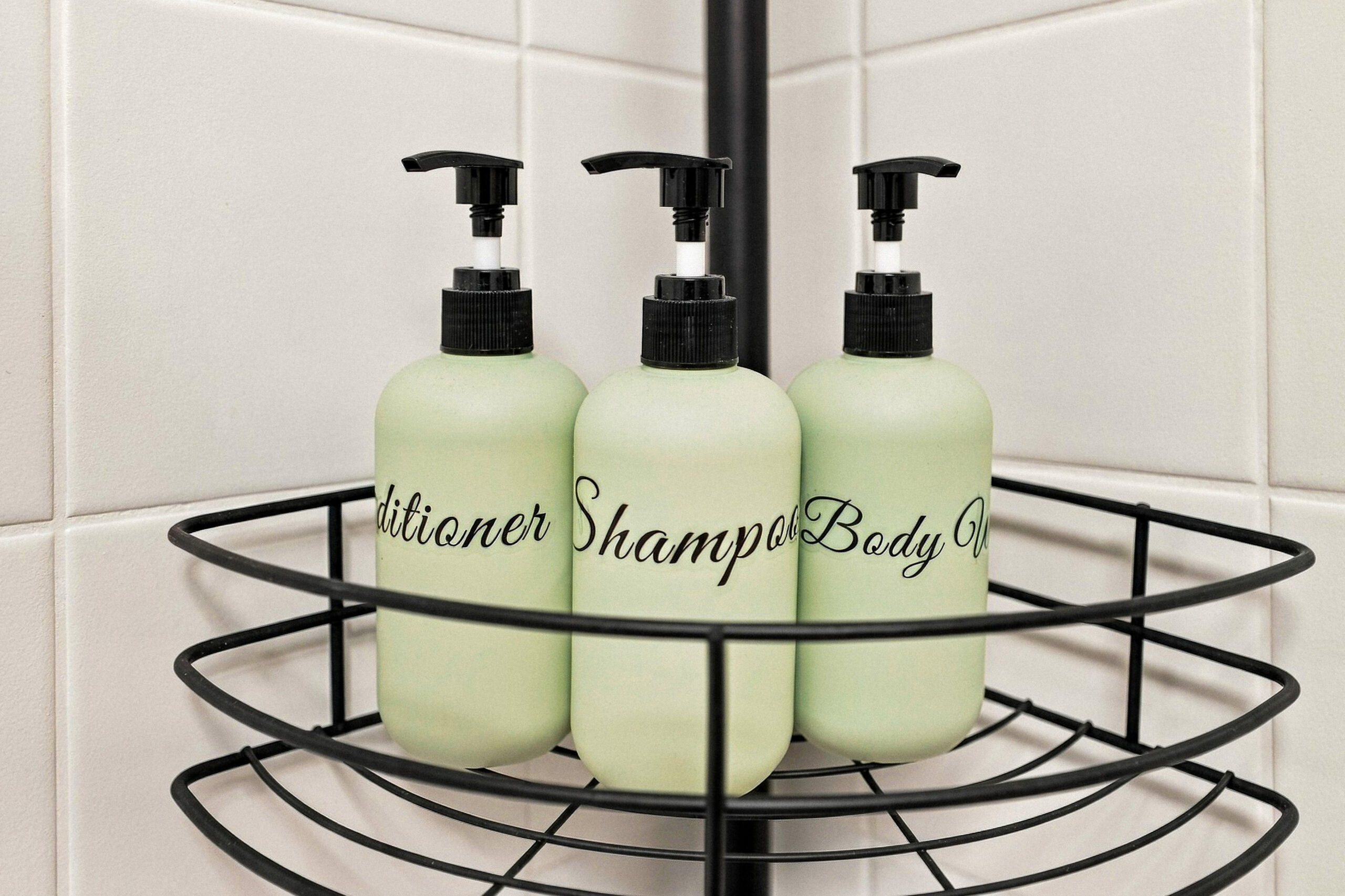 Shampoo, conditioner, and body wash bottles in shower caddy