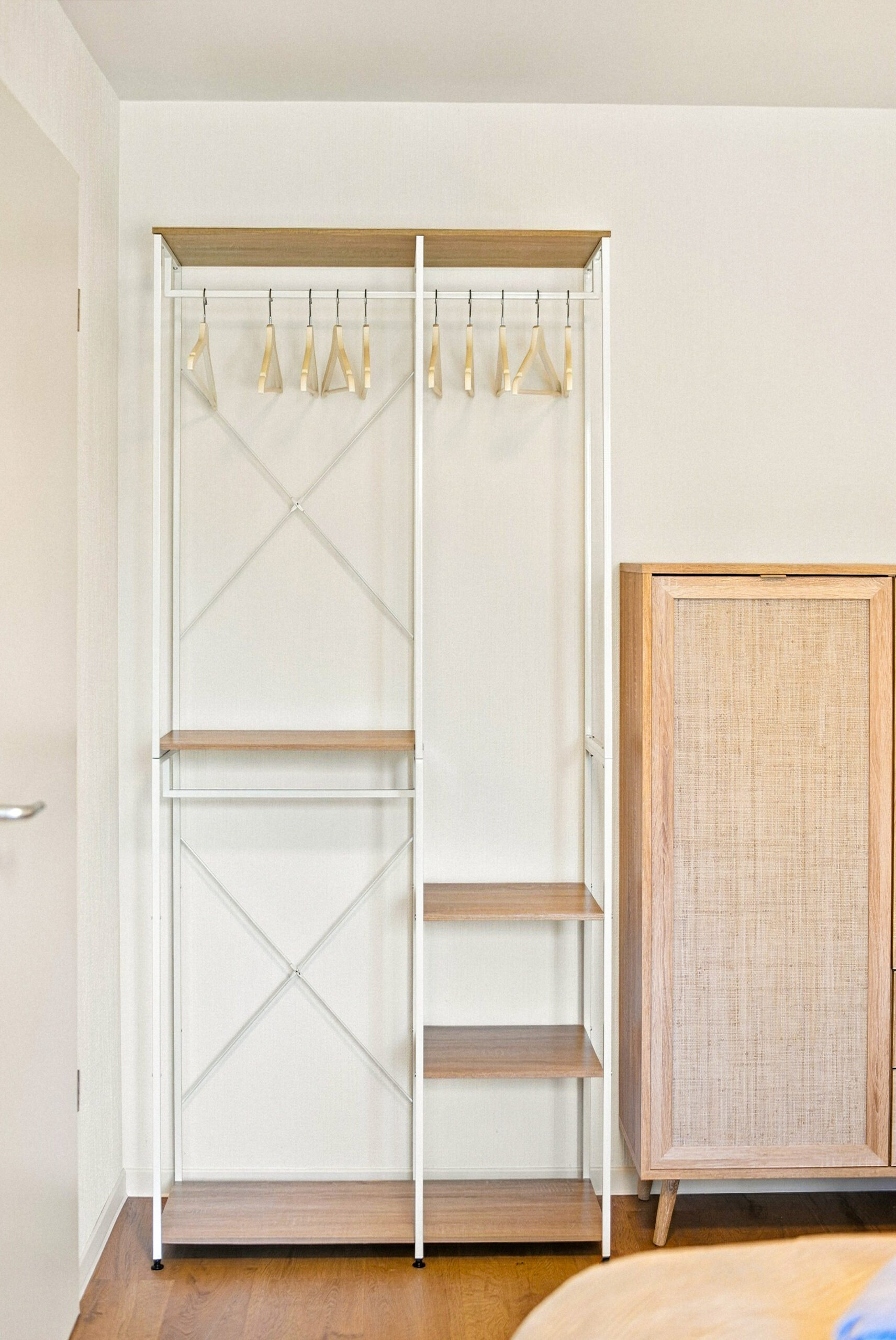 Open clothing rack with hangers and shelves
