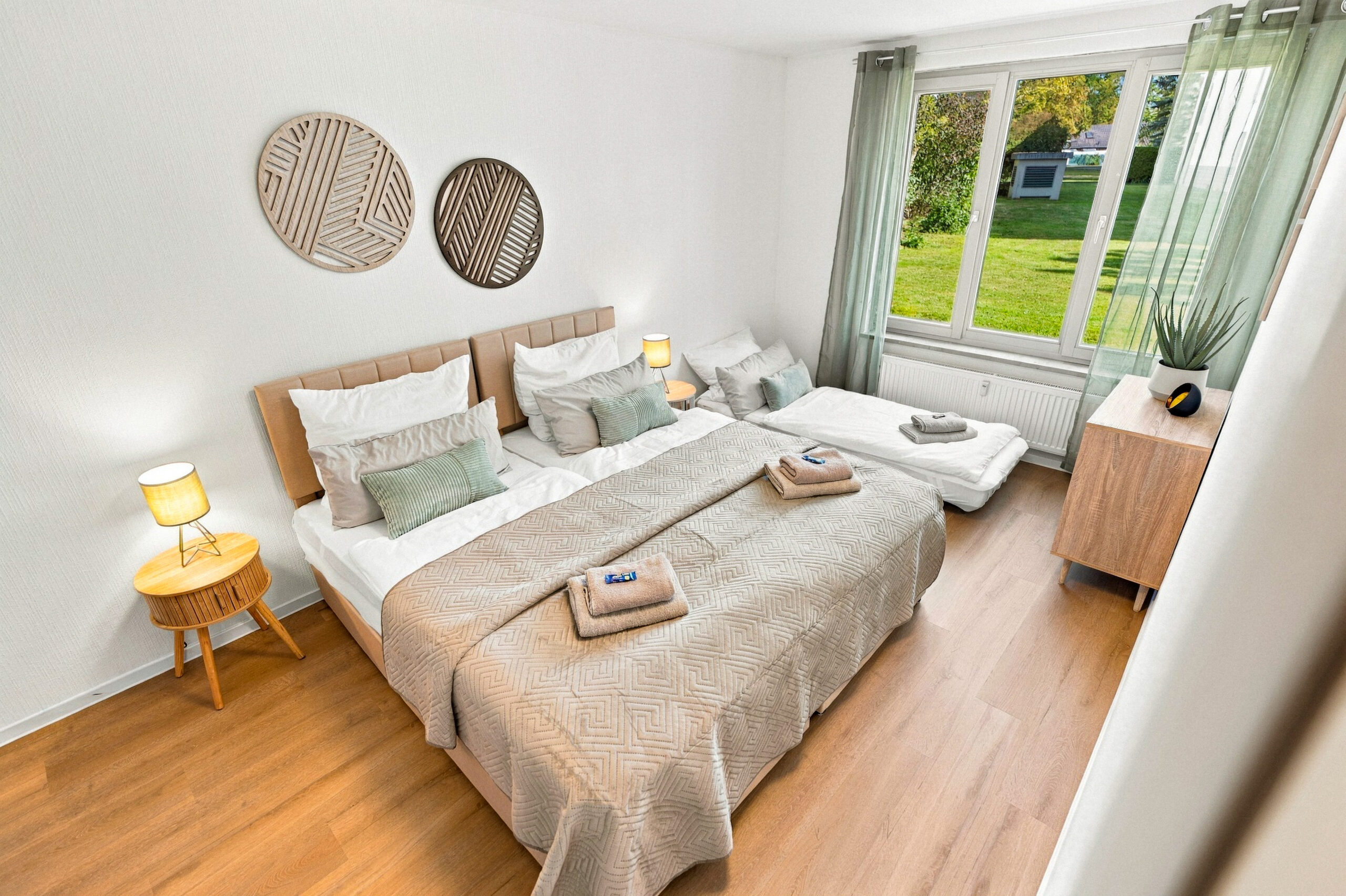 Bedroom with bed, towels and dresser view