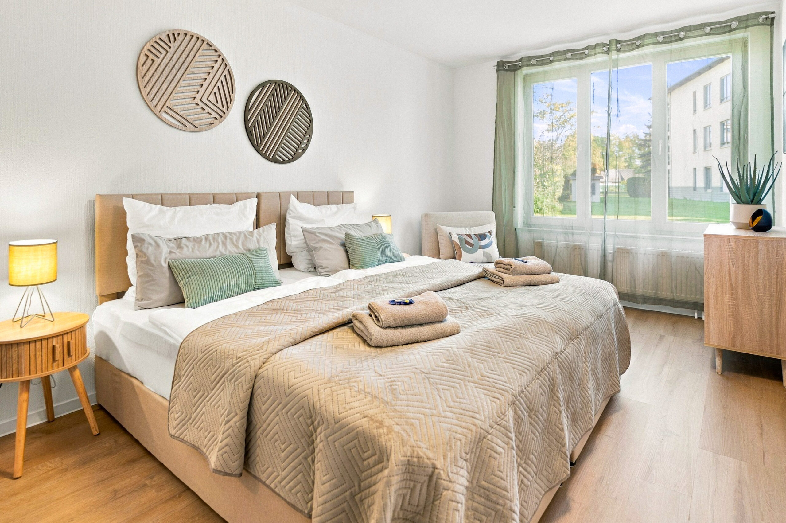 Bedroom with bed, dresser and green curtains