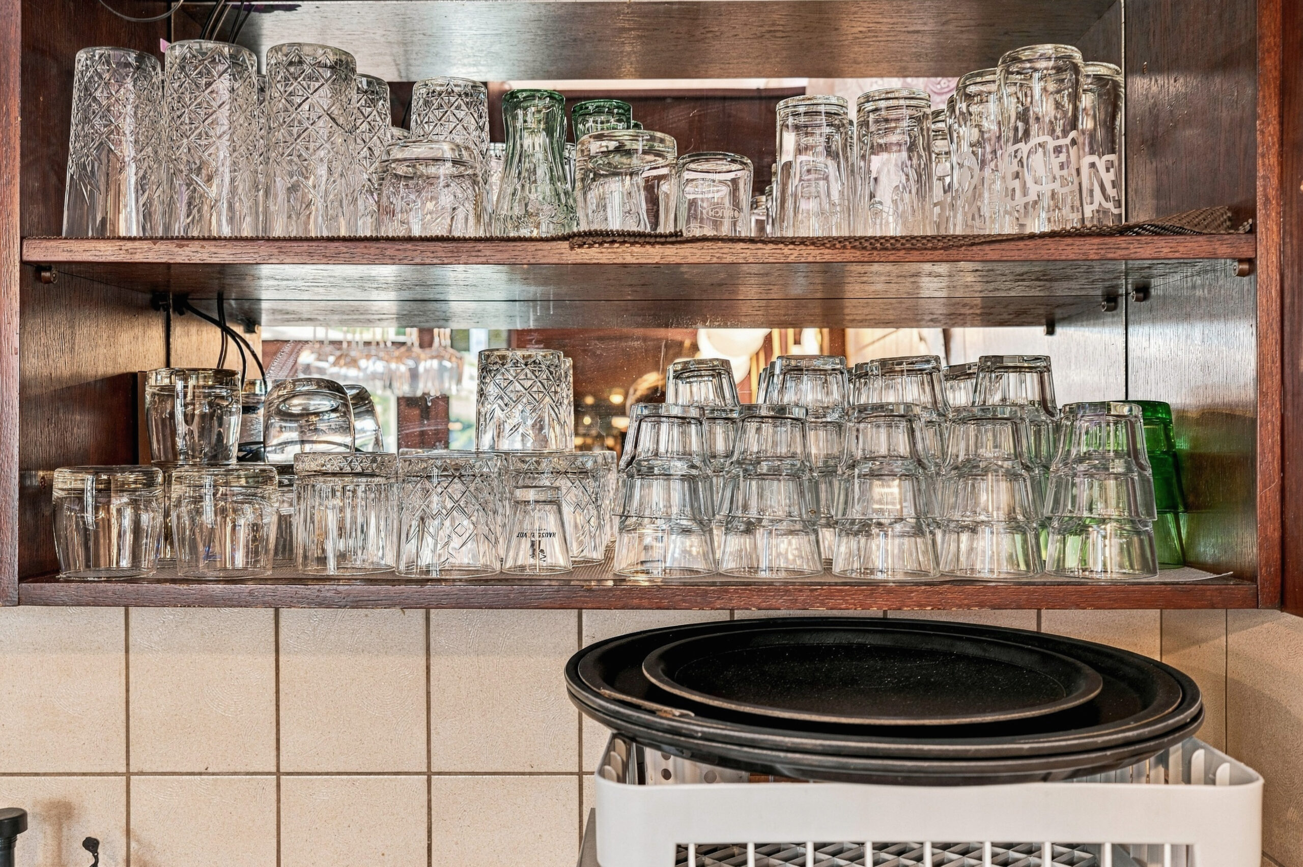 Shelves of glasses above bar counter