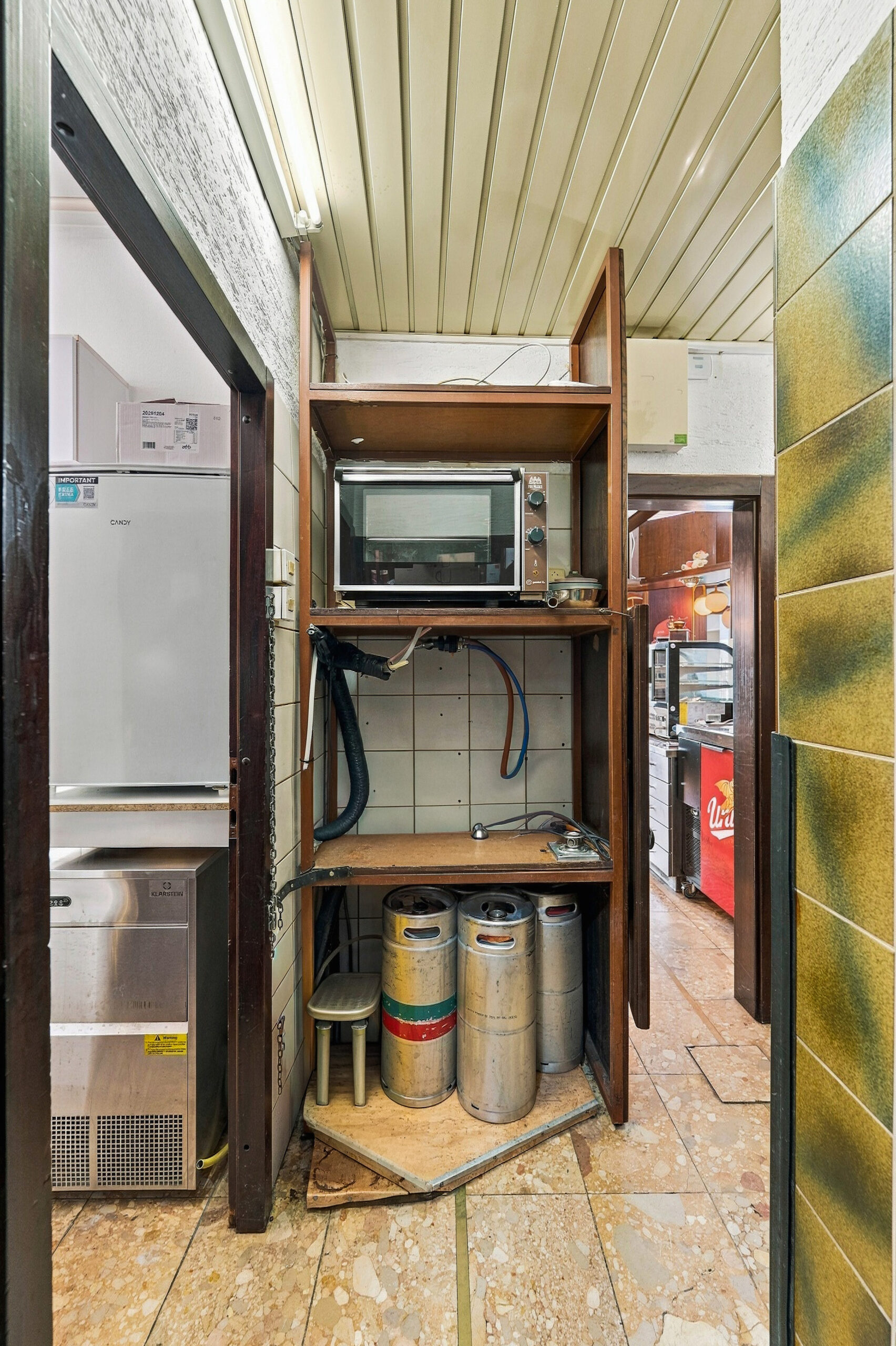 Storage closet with microwave and supplies