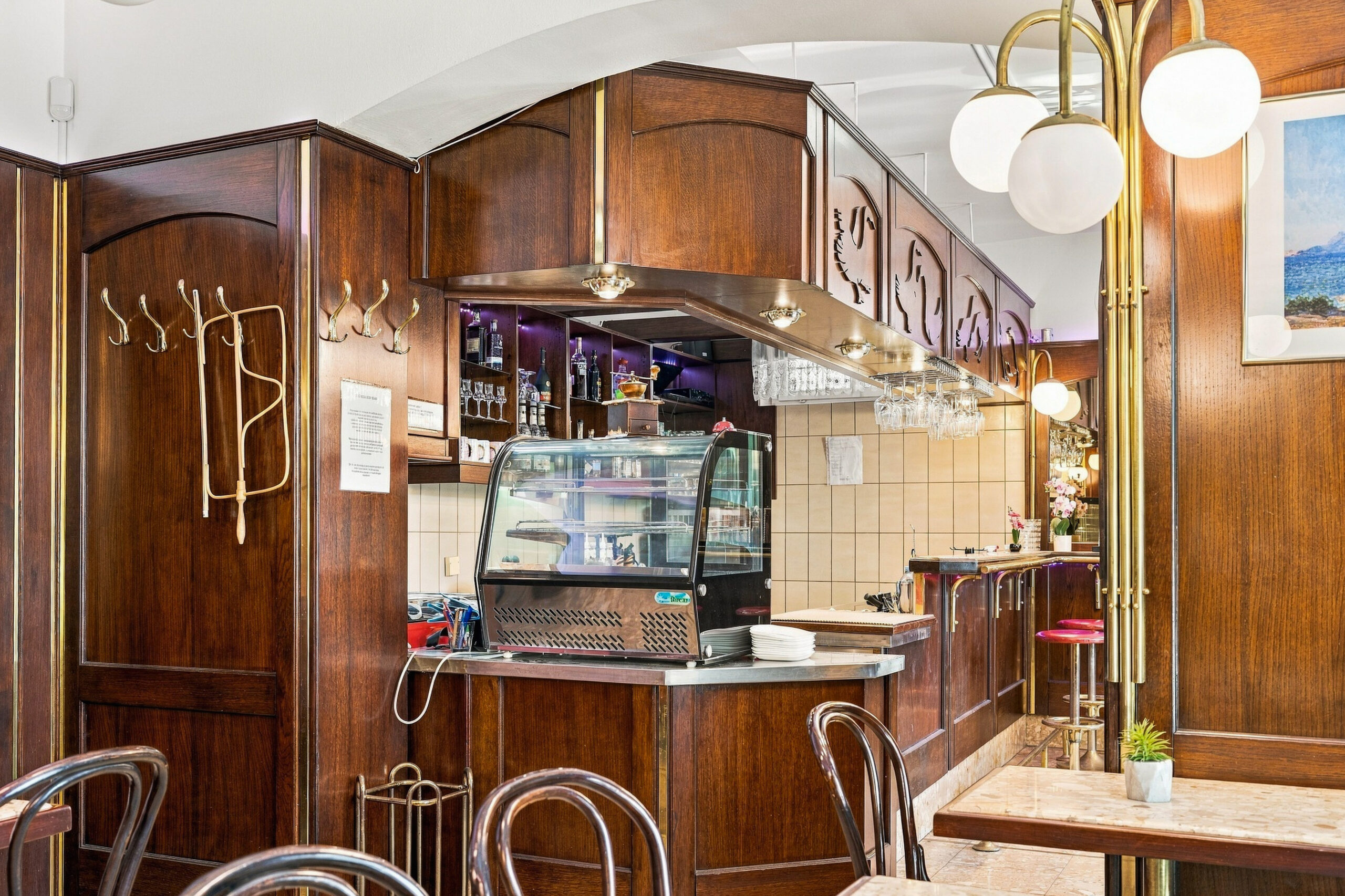 Wood paneled bar counter with pendant lights