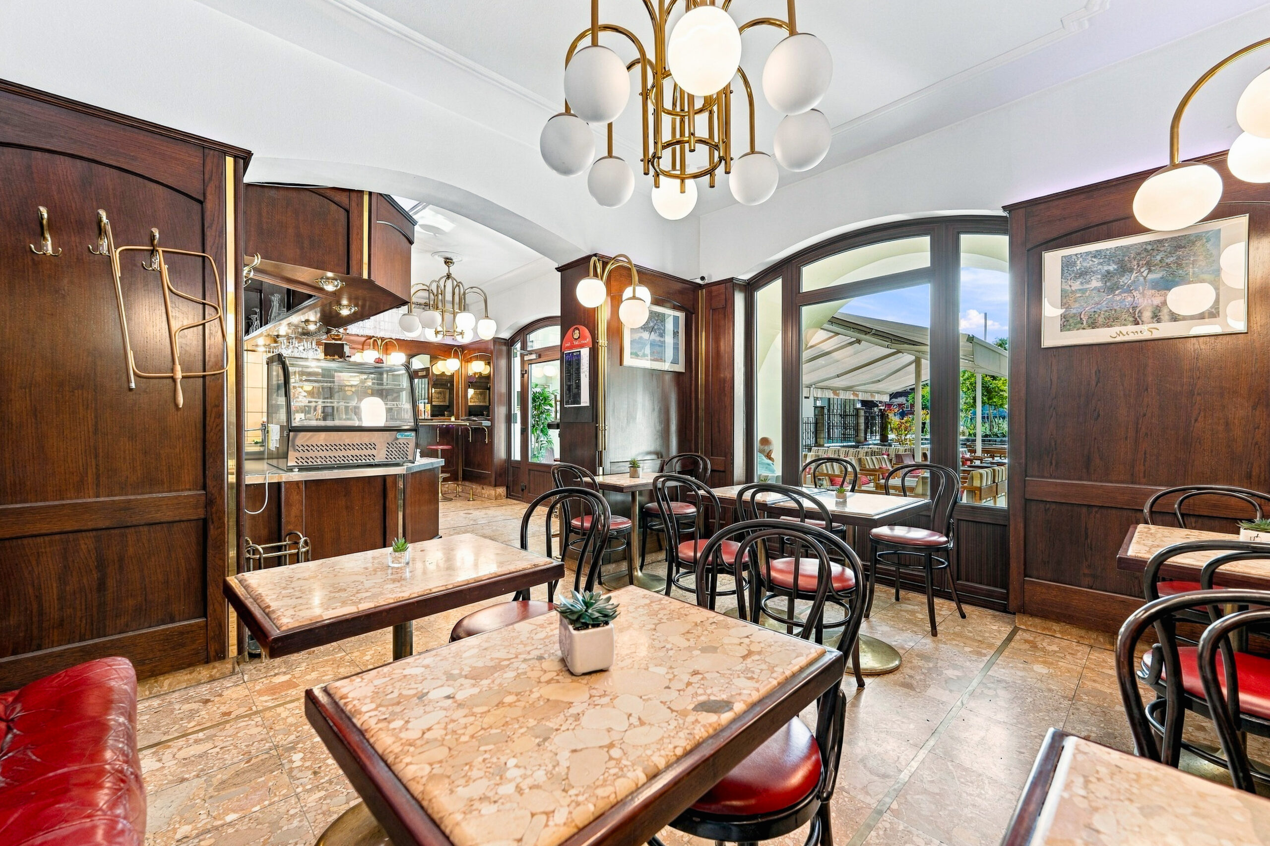 Bright cafe seating with marble tables and windows