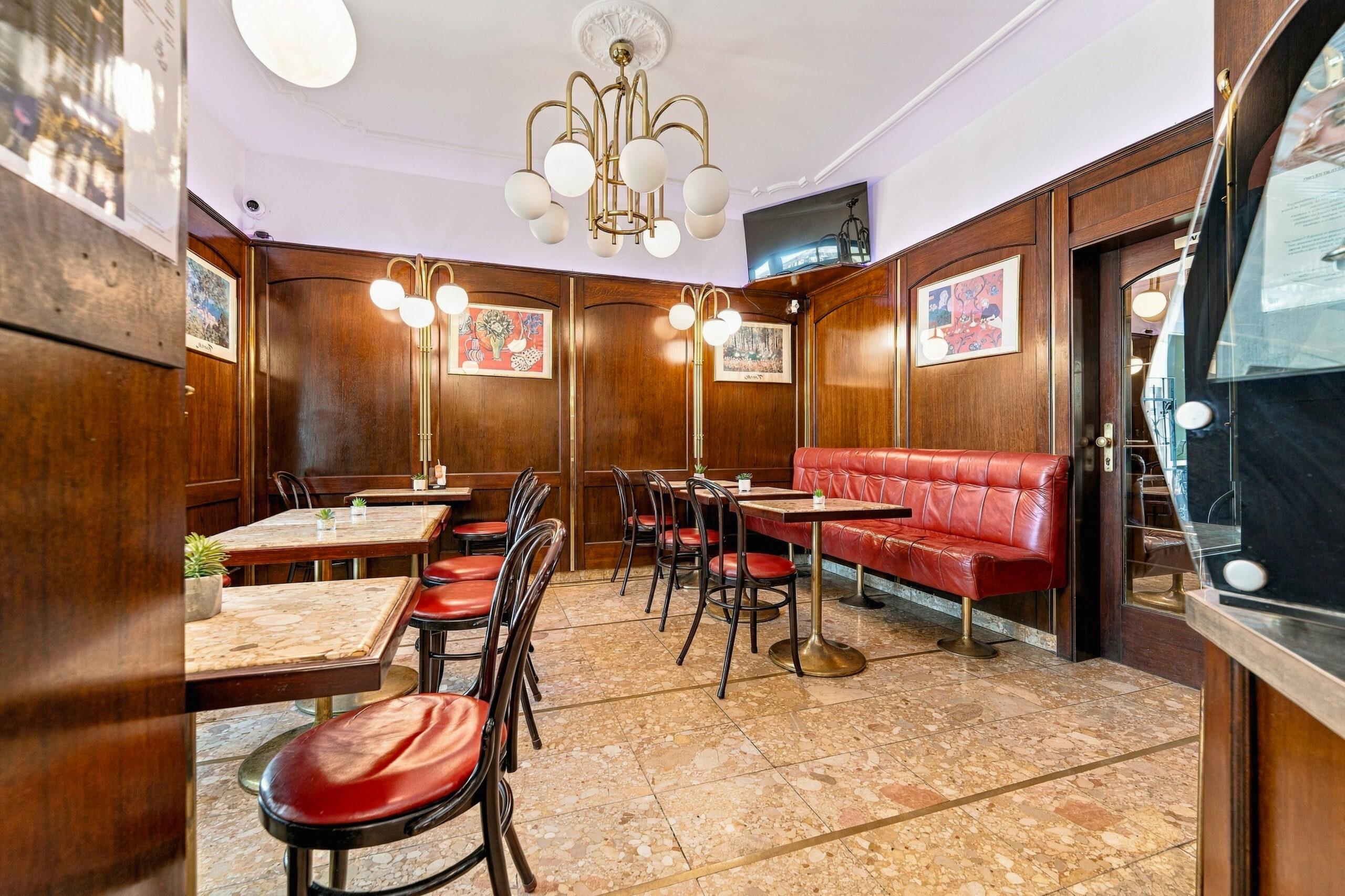 Cafe dining area with red booths and tables