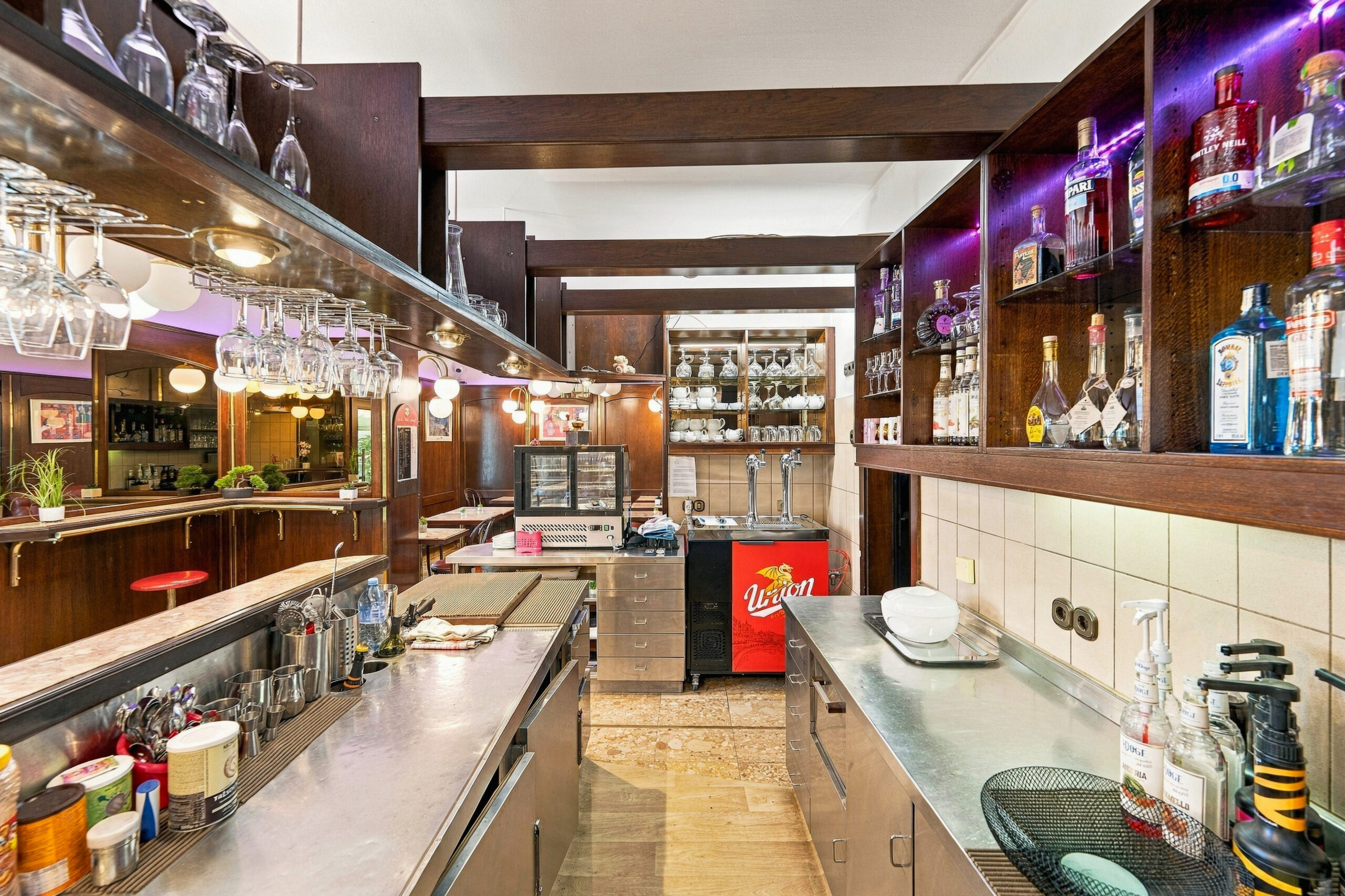Long bar counter with liquor shelves and lights