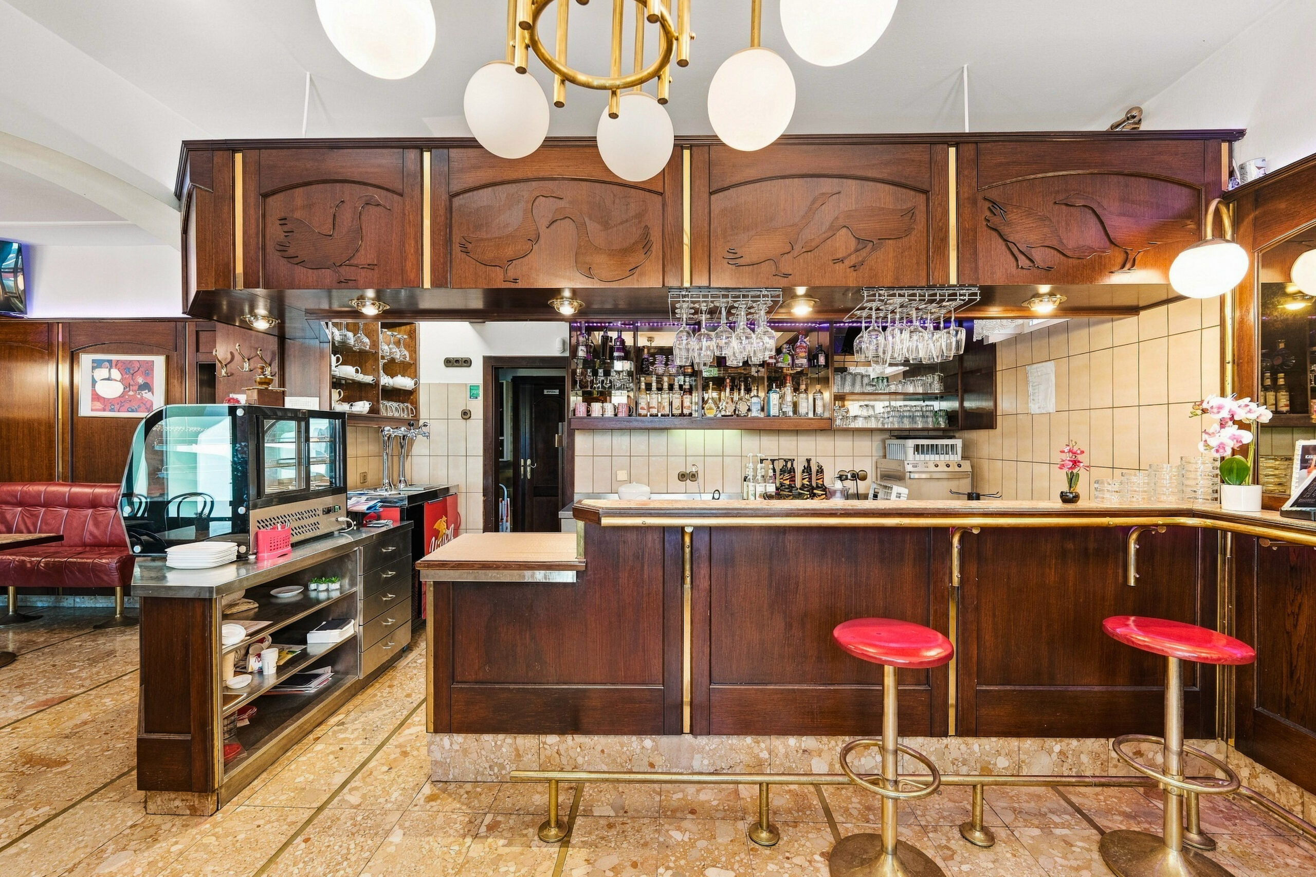 Wooden bar counter with stools and shelves