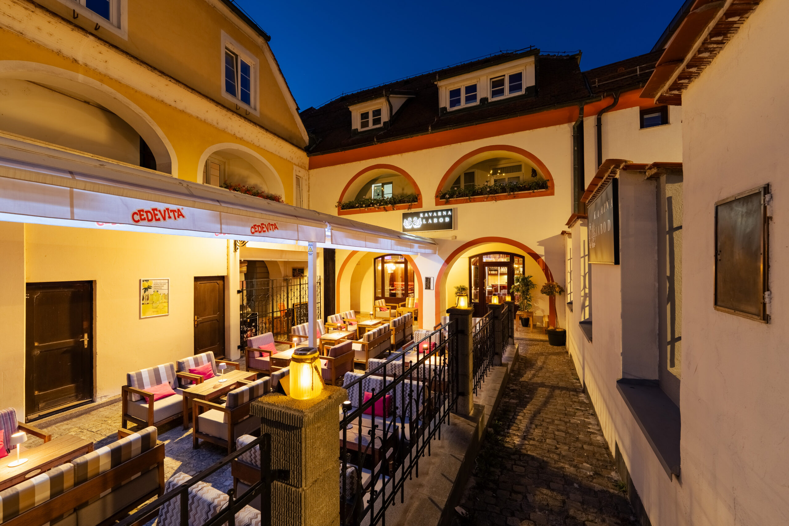 Covered walkway terrace with seating at dusk