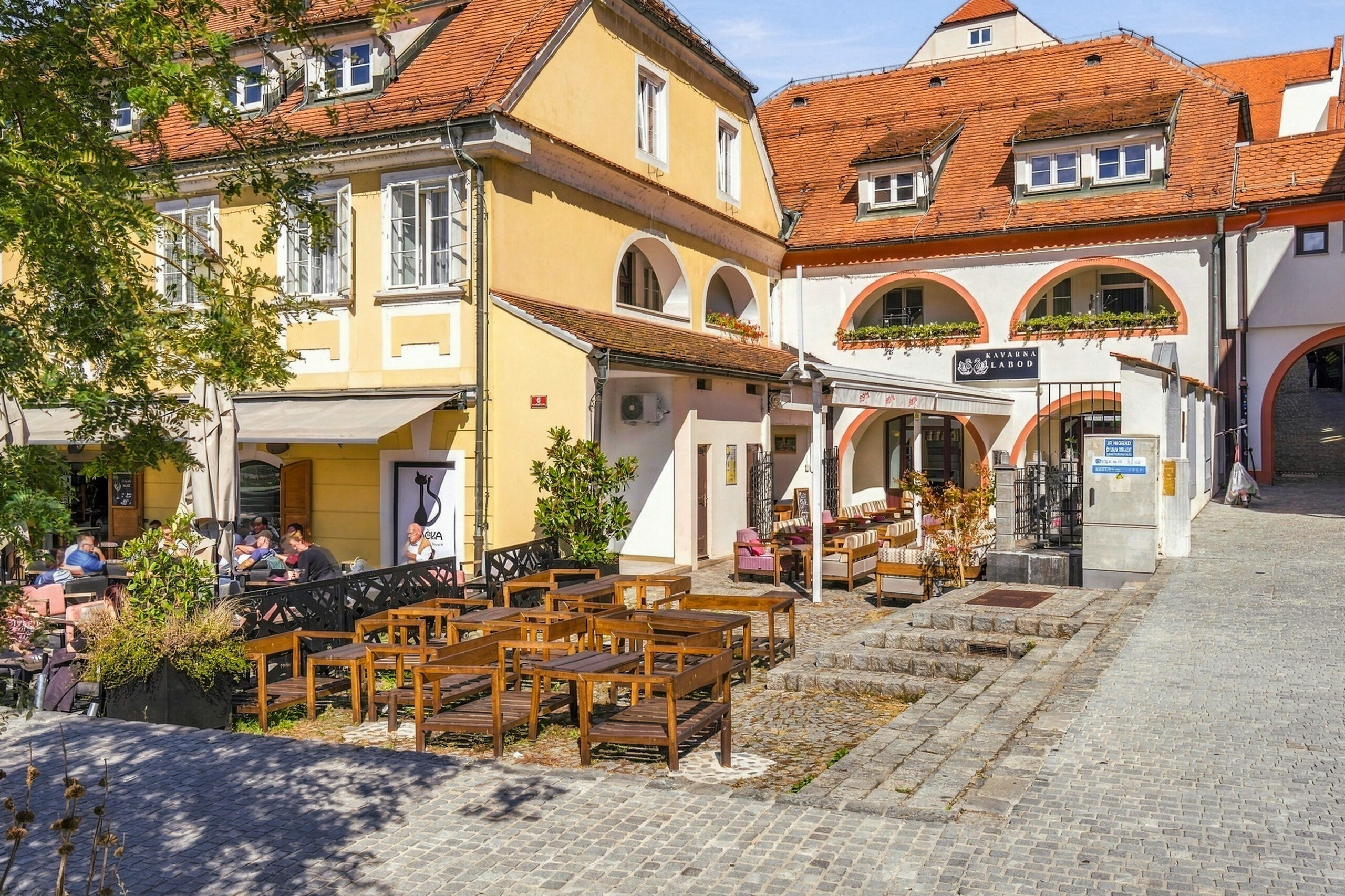 Street view of building with outdoor cafe seating