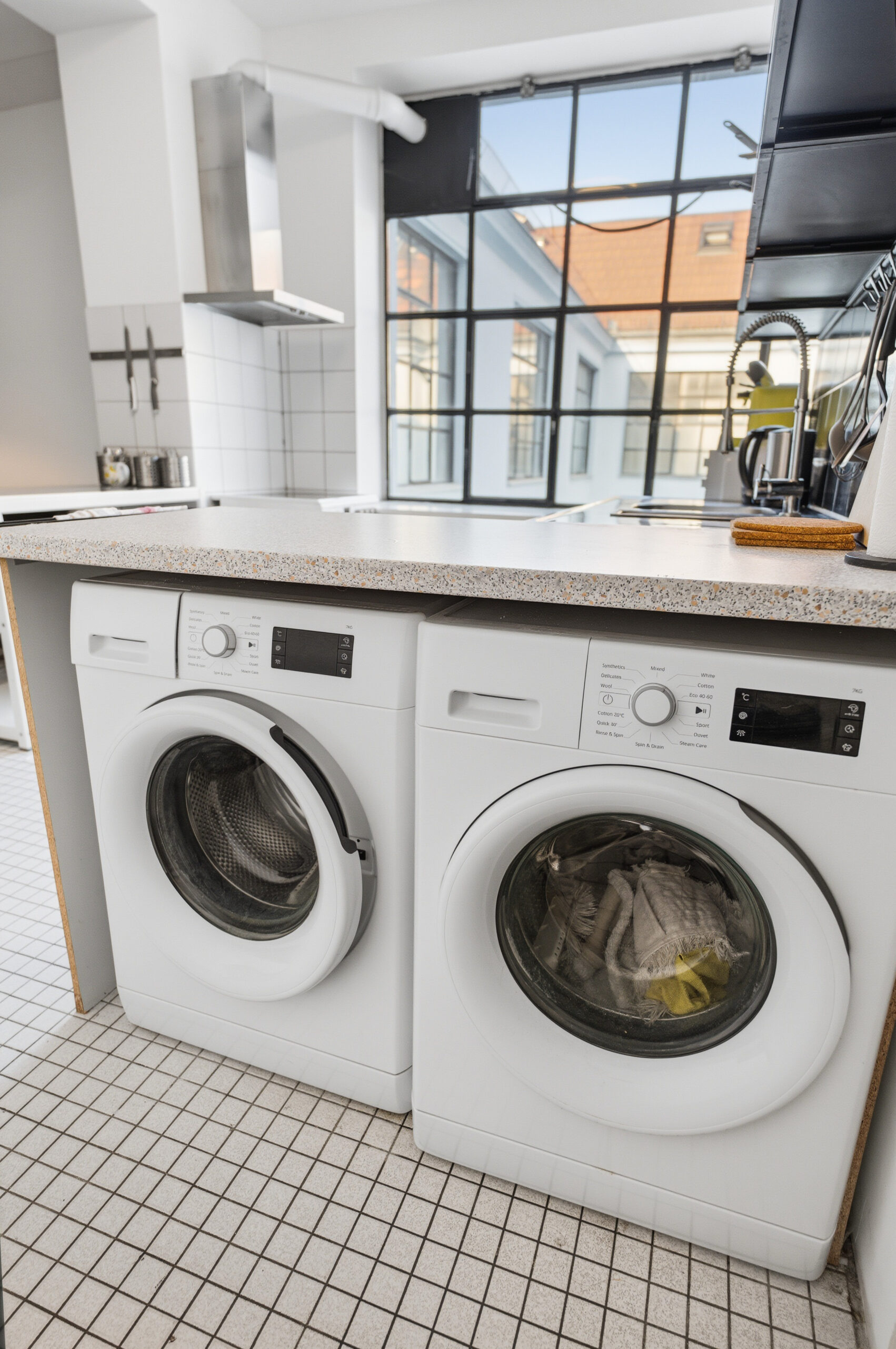 Two white washing machines side by side