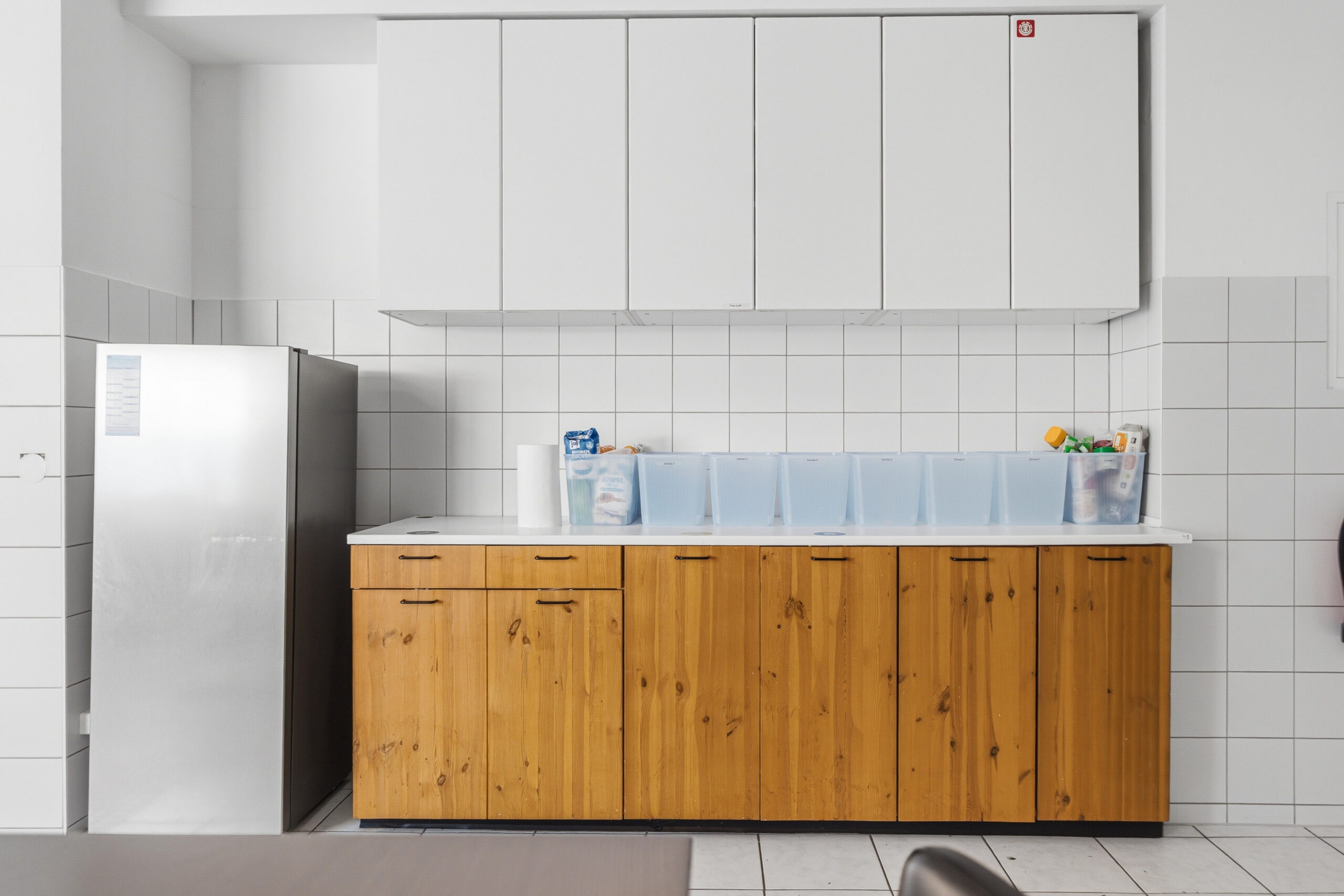 Simple kitchen with wooden cabinets and white walls