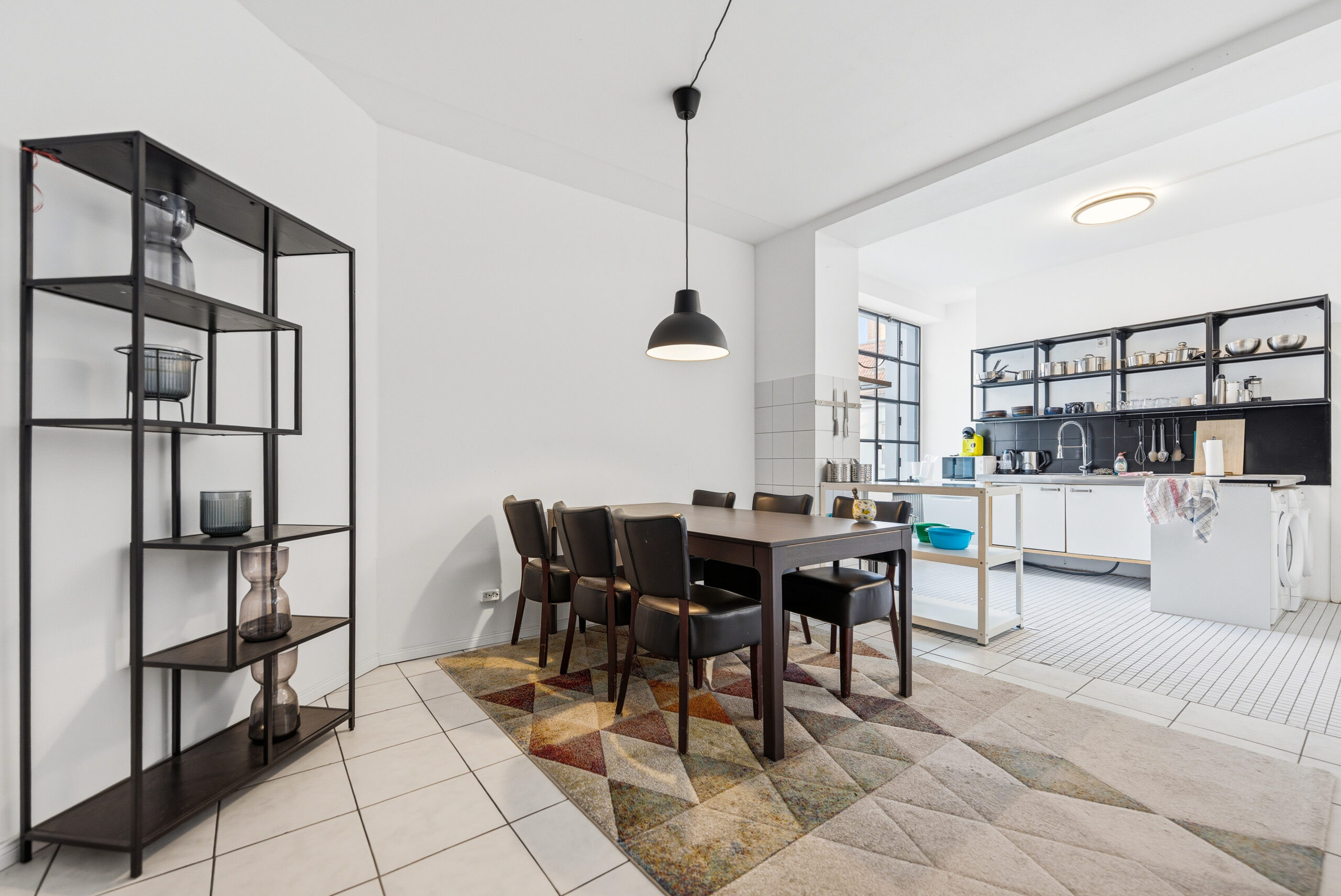 Open-plan living and dining area with dark furniture