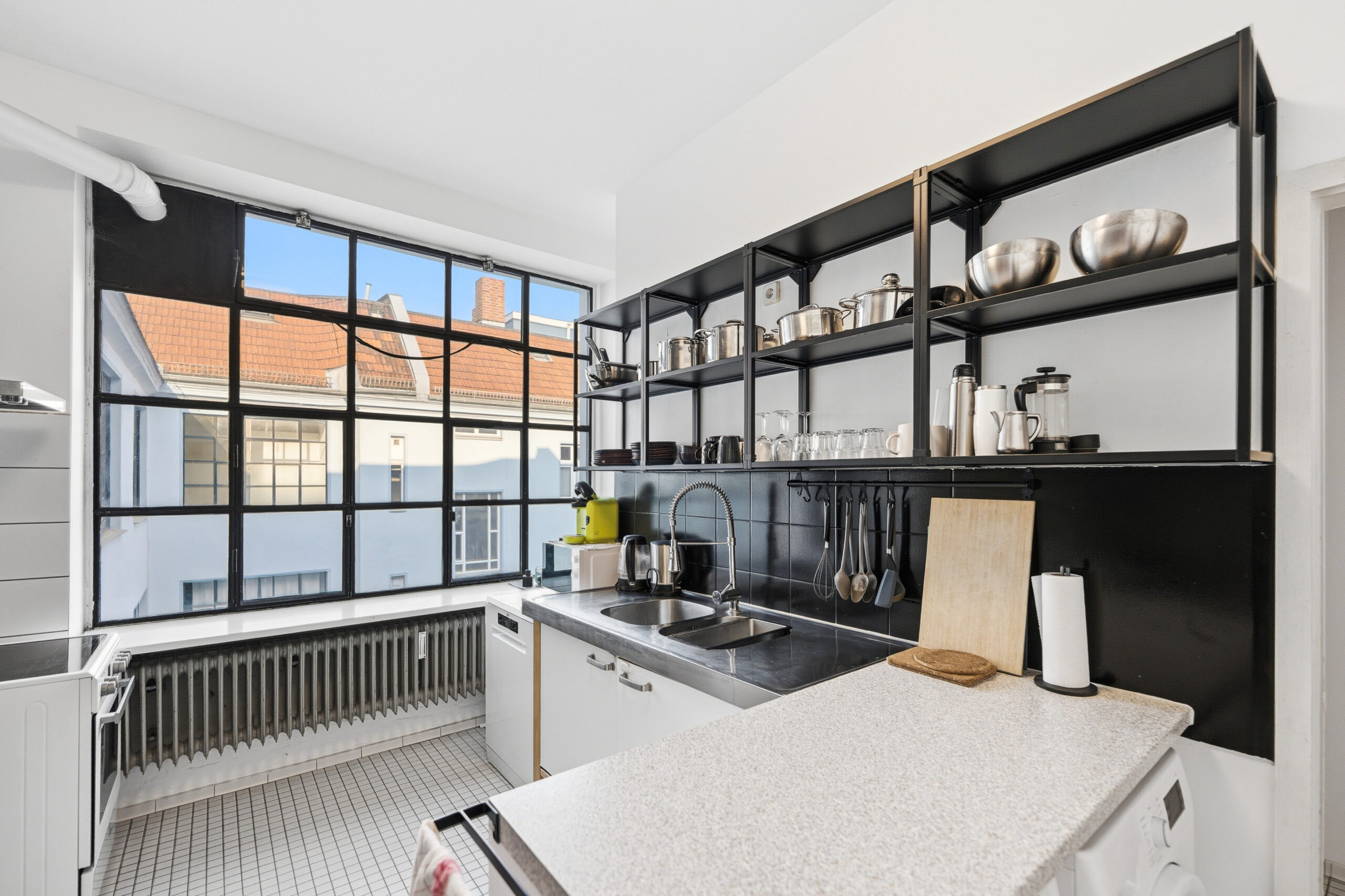 Modern kitchen with black shelving and industrial style