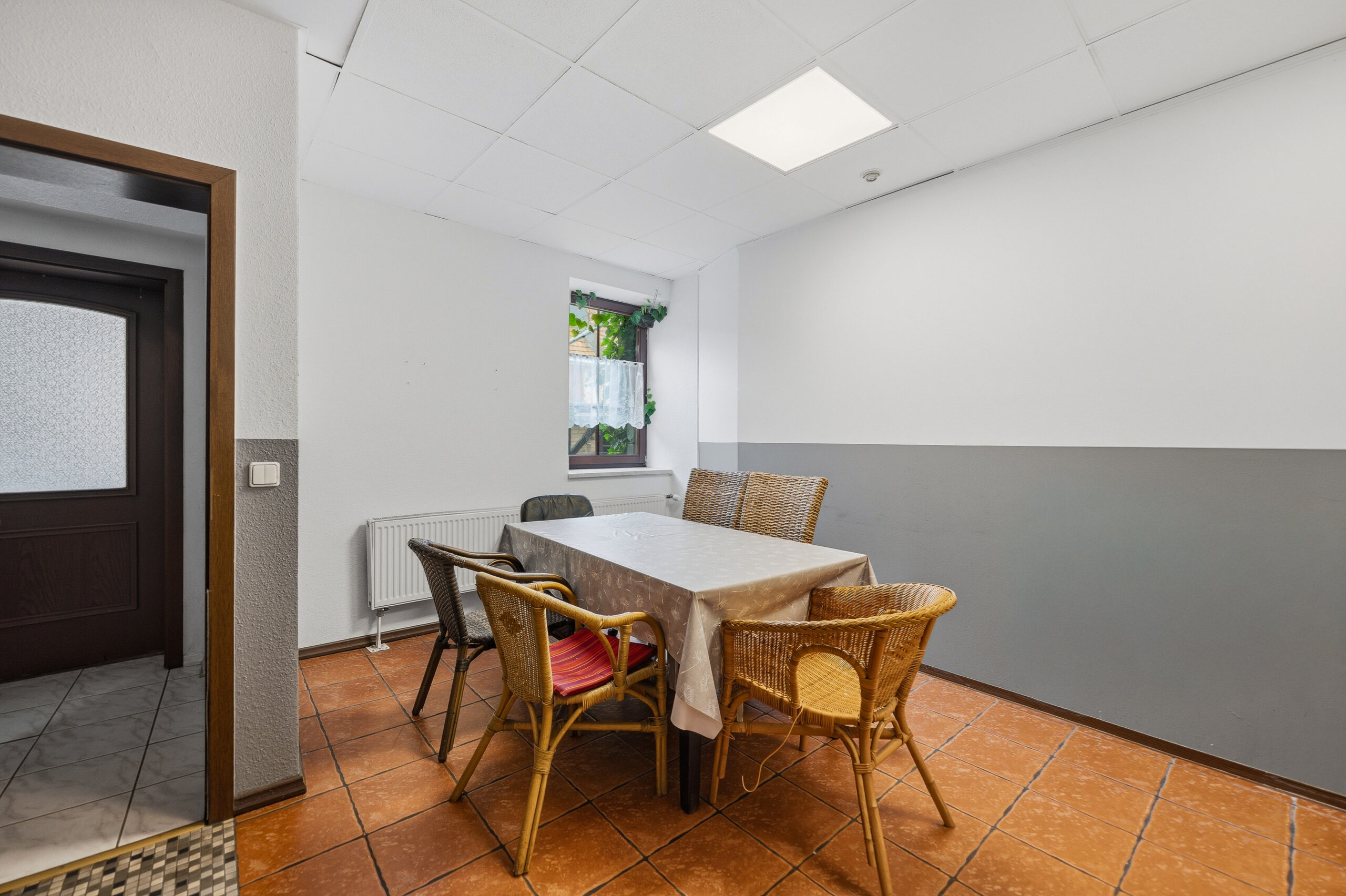 Small dining area with wicker chairs and table