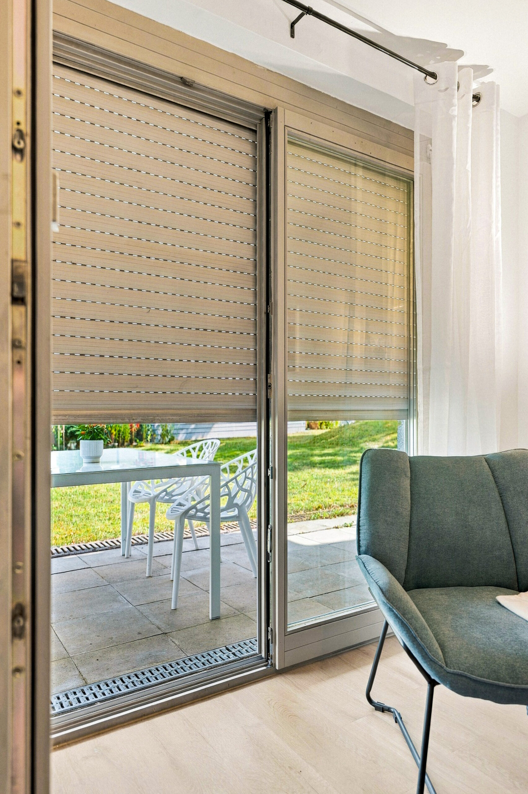 Sliding glass door with blinds and outdoor seating